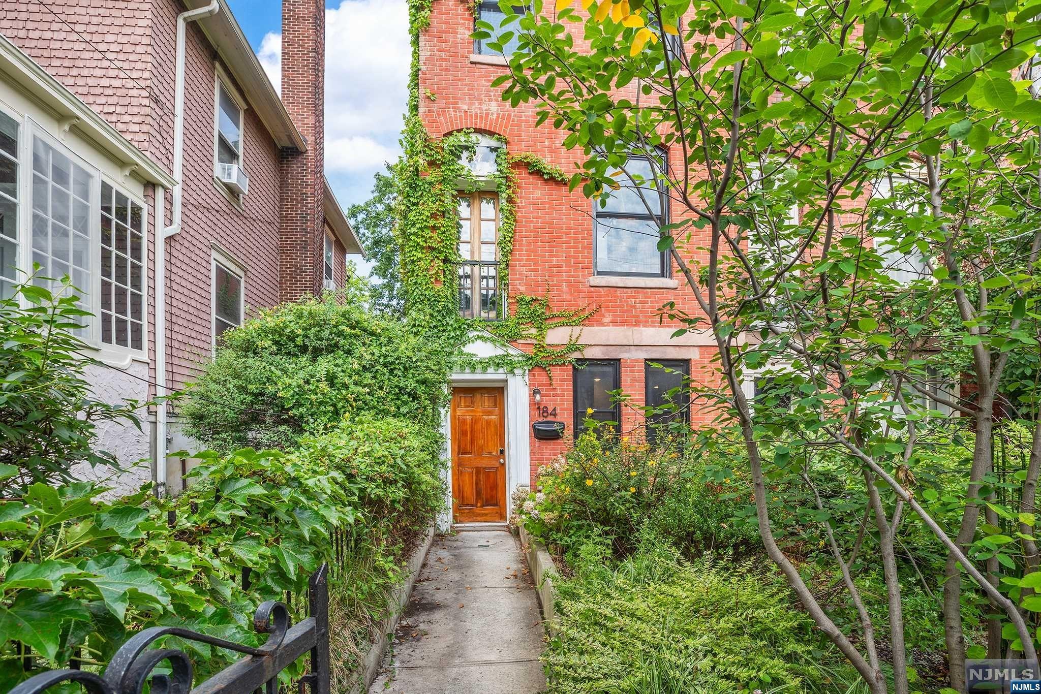 Own your dream row house in Jersey City, just 1.3 miles from Journal Square Path station for easy Manhattan access. This meticulously updated 1-family brick house retains vintage details with modern, bespoke updates. The main living area boasts natural light and wood floors, complemented by a kitchen featuring stainless steel appliances, marble countertops, and ample cabinets. Original details remain such as the original heart pine floors on the second and third floors, East Lake company door hardware, and slate fireplace mantels in many of the rooms. Enjoy central air and heat, endless hot water from the tankless hot water heater to fill the large soaking tub, a wildflower garden in your front yard, a spacious backyard ideal for entertaining, and a covered 2-car garage with EV charger. Located near the Light Rail, Lincoln Park, shops, and restaurants.