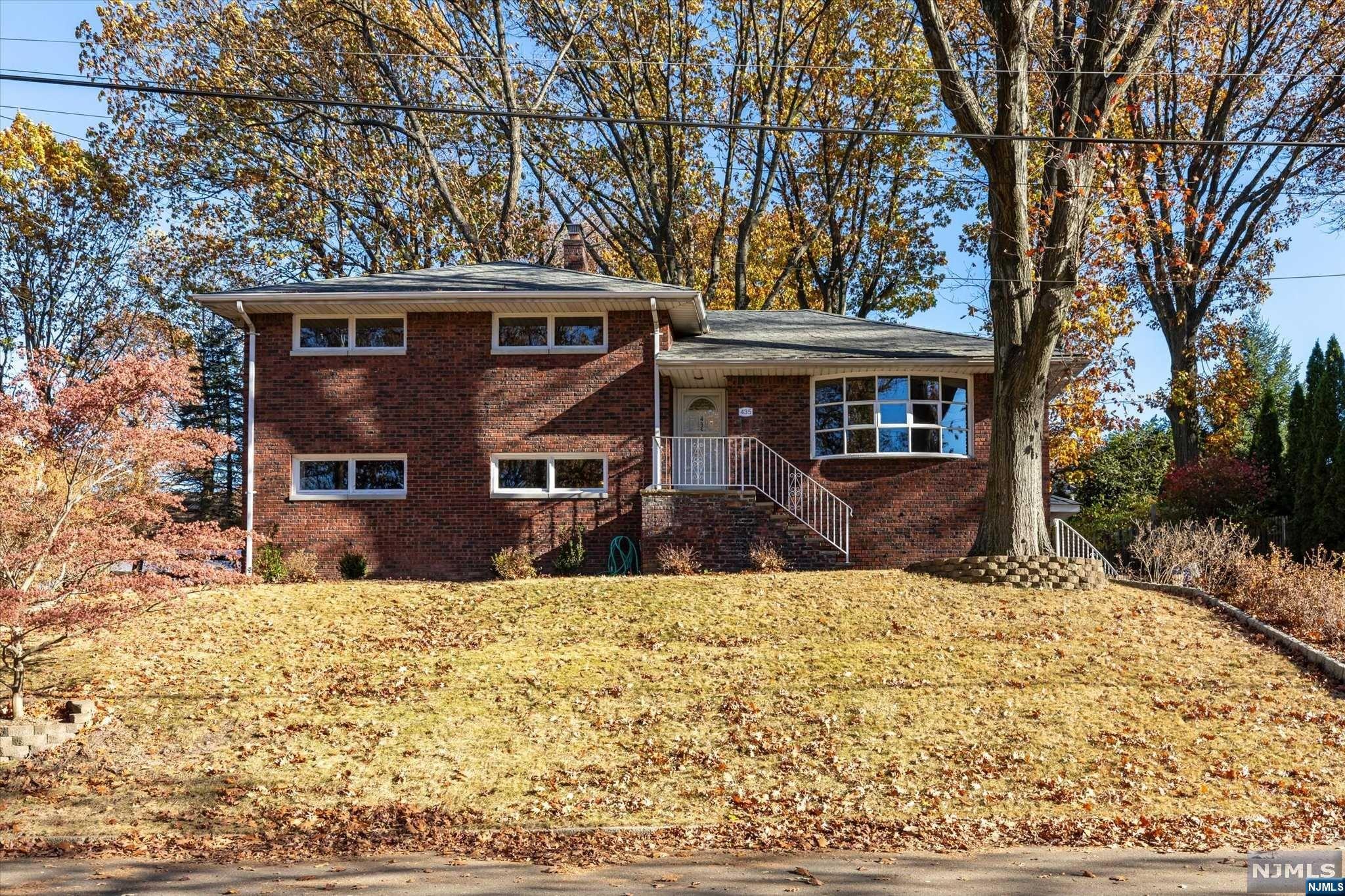 High Atop the East Hill of Leonia with Beautiful Sunset Views sits this Stunning Brick Split Level with a Modern Open Floorplan! The main floor will wow you with its abundance of space perfect for everyday living as well as entertaining guests. The newly renovated kitchen with breakfast bar, stainless appliances, and quartz counters is open to the dining room and family room which features new flooring, skylights, lots of windows and natural light. On the lower level you will find an oversized recreation room where you can play or watch TV and relax by the brick fireplace along with a full bath that includes a washer and dryer. You can access the backyard from this level or main floor family room. The 3rd level has a primary bedroom with an updated primary bathroom plus 2 more bedrooms and the main bathroom. Convenient interior access to garage and an adjacent room that can be used for storage or an office. This is a winner!