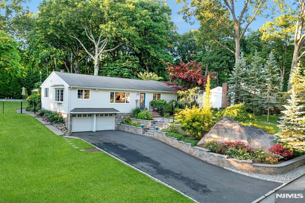 Please TEXT listing agent for more info @ 201-647-4225. Nestled in the desirable Cragmere section of Mahwah, this 4-bedroom raised ranch offers comfort and style and the ideal home for entertaining with family and friends. An open living and dining area flows into a modern kitchen with a large island, granite countertops, and stainless appliances. Adjoining is a cozy family room with a wood-burning fireplace and vaulted ceilings; ideal for cozy winter evenings with family. The primary suite offers high ceilings, a walk-in closet with custom shelving and built in dressers, a large bath with jetted tub, double vanity, and shower stall. You will love the patio access as well. The finished basement includes laundry, storage, and garage access. A large area for play, working out, or a home office. The backyard is truly an oasis. Think graduation parties, prom night, birthdays, friends gathering! You will love the lawn space for play, a cozy patio with string lights for lounging and dining, and a 20x40 heated pool to create a lifetime of memories. Enjoy gardening? You will love the raised garden beds Composting? Weâ€™ve got you covered! The fenced in yard is ideal for kids and dogs to play safely. You will love the mature landscaping and flowering plants! Mahwah offers low taxes, Blue Ribbon schools, proximity to hiking, lakes, and convenient NYC transit with both bus and train access. Come make this your next home in a true neighborhood. Some photos are virtually enhanced.