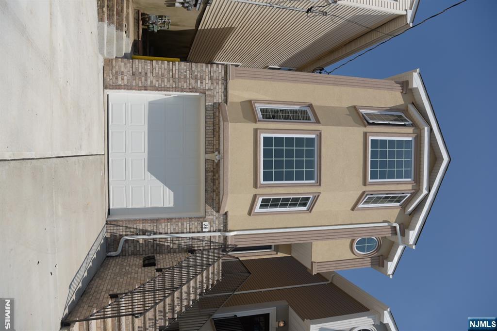 Modern 2-family home at 28 Davis St, 5 beds,5 baths across 2 private units.