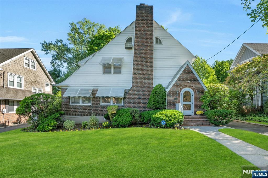 Welcome to this expanded Tudor offering exceptional space, charm, and value in one of Teaneck's most desirable locations. This well-maintained home provides a tremendous opportunity to move right in and enjoy its generous layout and beautiful setting. The first floor features a spacious living room with fireplace, formal dining room, iand nviting kitchen with built-in banquette seating perfect for gathering with family,. The first floor also features a powder room and a sun-filled den surrounded by windows. A lovely three-season room overlooks the serene backyard, perfect setting for relacin and entertianing.The second floor offers a primary bedroom with ensuite bath, two additional bedrooms, and a full hall bathroom. The finished third floor adds even more flexibility with a generously sized bedroom and separate office, ideal for guests, work-from-home needs, or hobbies. The beautifully finished basement provides additional living and recreation space along with a convenient half bath. Additional features include mini-split air conditioning in the primary bedroom and one secondary bedroom, through-wall air conditioning throughout much of the remaining home, and a detached two-car garage. Ideally located near houses of worship, shopping, parks, and transportation, this spacious home offers the perfect blend of elegance comfort and functionality.
