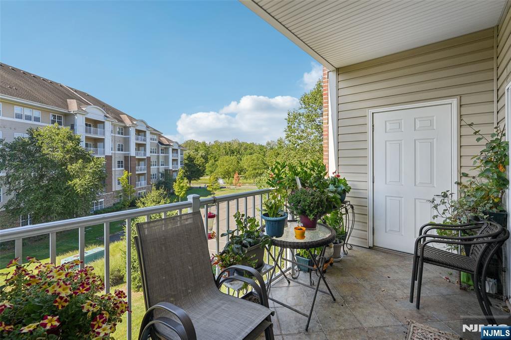 Welcome to this beautiful Colfax END-UNIT condo in one of the newer buildings of Wanaque Reserve, an active adult 55+ community. Move-in ready and filled with natural light, this 2-bedroom, 2-bath home offers picturesque views of the mountains and pond. The open floor plan features unique polished concrete floors, a spacious den with French doors that open to the dining room, and sliding glass doors that lead to a tiled balcony perfect for relaxing. The primary bedroom suite is a true retreat with a tray ceiling, walk-in closet, additional double closet, dressing area, and a private ensuite bath. A second bedroom, full bath, and in-unit laundry provide comfort and convenience. This home also includes TWO DEEDED UNDERGROUND PARKING SPACES 80 & 83. New hot water heater with auto shut off valve. Wanaque Reserve offers a resort-style lifestyle with a clubhouse that features a cafe , fitness center, theater, sauna, ballroom, and both indoor and outdoor pools. With more than 45 clubs and activities, including travel, tennis, pickleball, golf, canasta, and poker, there is something for everyone. This property combines comfort, style, and community in one of the area's most sought-after locations