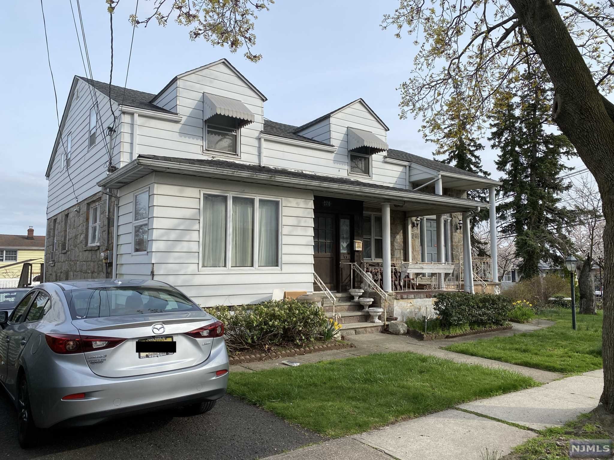 Large 2 family ON A 100x100 LOT. The main unit has 3 bedrooms and 2.5 baths. The second unit is a large studio. Two car detached garage with a loft. Separate electric and gas. Sold as is.