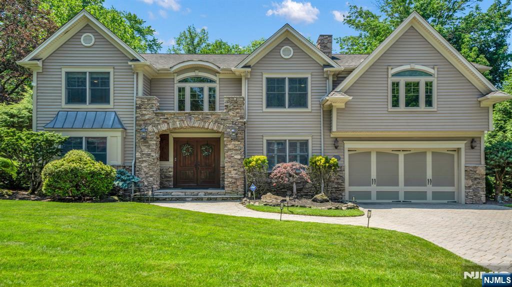 East Hill Opportunity! Beautifully maintained 4 bedroom, 3.5 bath center hall colonial set in one of Cresskill's most sought-after neighborhoods. A grand marble foyer welcomes you into a classic center hall layout featuring formal living and dining rooms, an eat-in kitchen with granite countertops, stainless steel appliances, and custom maple and cherry cabinetry. The spacious family room showcases a marble fireplace and elegant glass pocket doors, creating the perfect setting for everyday living and entertaining. A mudroom, laundry room, and powder room complete the main level. The second level offers a primary suite with walk-in closets and a luxurious bath, plus three additional bedrooms and a full bath. The finished lower level features a recreation room, office, full bath, and flexible living space. Enjoy a private patio with surround sound and professionally landscaped outdoor space. Conveniently located near top-rated schools, parks, downtown shopping and dining, and NYC transportation. An exceptional East Hill offering combining location, space, and value!