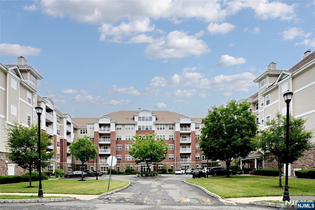 More than a home...it's a lifestyle. Third floor 1768 SF Colfax unit in building four with a private hall entrance is in the Del Webb 55+ active adult community of Wanaque Reserve set on more than 440 acres of beautifully landscaped and wooded grounds. Although the unit is on the third floor, based on the location in the building, it is the top floor...no unit above it. The home features a living room with sliding doors to a balcony with a tranquil lawn/woods view, dining room, den/home office, with French doors adding a touch of elegance, eat-in-kitchen with stainless steel appliances, granite countertop and tile backsplash, plenty of cabinets and pantry, laundry room off the kitchen, primary bedroom ensuite with tray ceiling, walk-in-closet and another closet, full bath, walk-in-shower, double vanity and private toilet room, 2nd bedroom and full bath. The home is near the 20,000 SF clubhouse with indoor and outdoor pools, sauna, cafe, exercise room, and more than 45 clubs and activities. Some of the clubs and activities include the travel club (four or five trips as well as casino trips each year) , tennis, pickleball, canasta, mahjong, poker, bocce, shuffleboard, ballet, art classes, etc. Wanaque Reserve offers a luxurious lifestyle for its residents with a focus on modern amenities, security, and a sense of community. The recent renovation adds a fresh and updated living environment.
