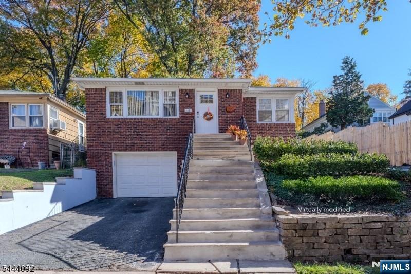 Back on the market due solely to the previous buyer's financing. The home appraised successfully, inspections are complete, and it's ready for a quick closing! Move right into this beautifully updated, sun-filled 3-bedroom, 2-bath home in the highly desirable Seven Oaks neighborhood, just a short walk to the NYC Midtown Direct train. Perched on an elevated lot, it offers enhanced privacy, abundant natural light, and the convenience of a private garage. The kitchen and both bathrooms have been completely gut renovated, including a modern primary en-suite. Refinished hardwood floors and fresh interior and exterior paint create a bright, modern, move-in-ready home. A full, partially finished basement provides excellent storage and flexible space for a gym, recreation room, craft area, or future expanded living area. Home has an updated energy efficient gas furnace. Conveniently located near shopping, restaurants, parks, and major highways, this turnkey home offers the perfect blend of style, comfort, and convenience.