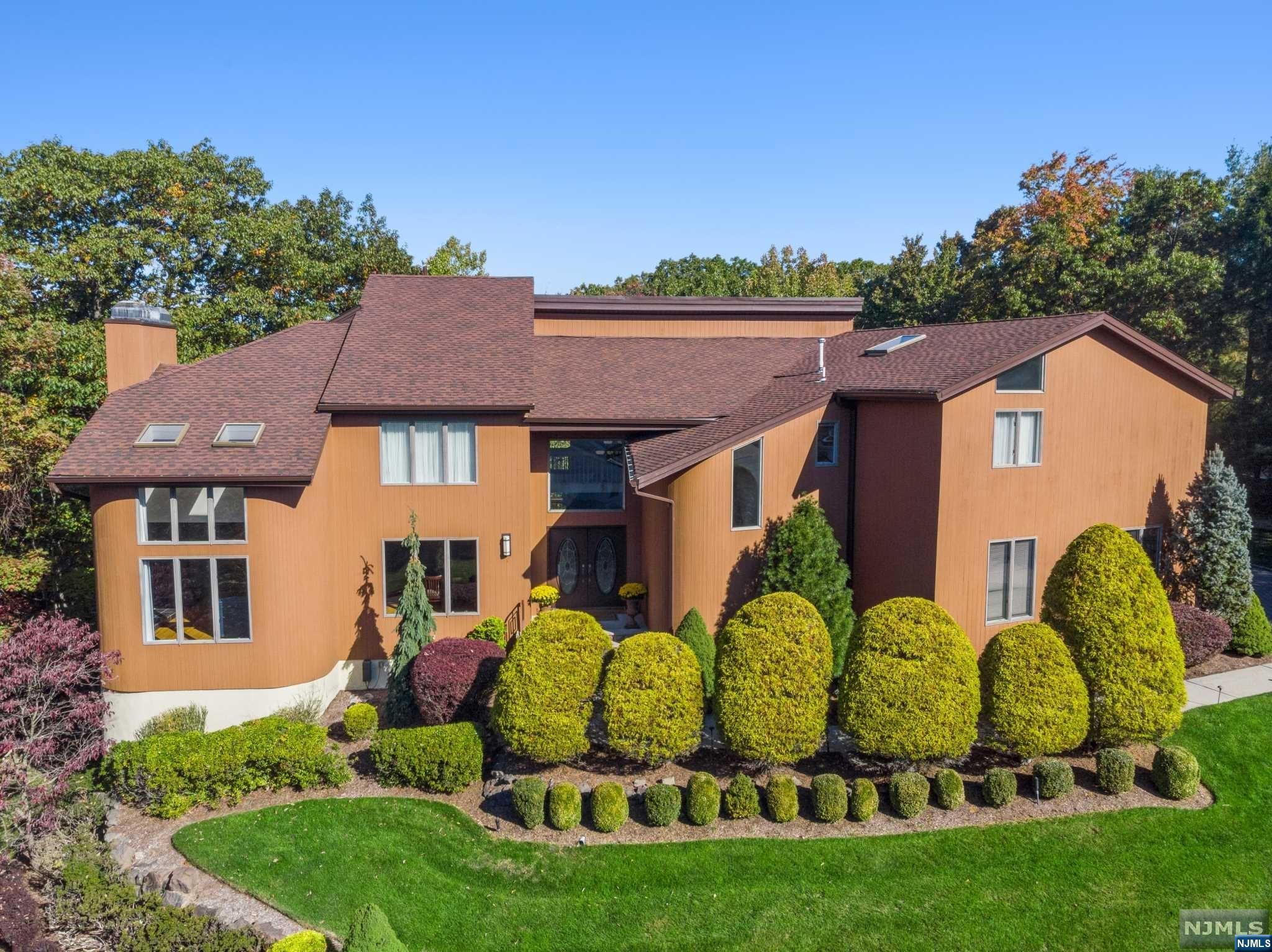LOCATION! Bordering Montclair and the Mills Reservation with an added surprise of a walking path to the Upper Montclair train station. Located on a private cul-de-sac with with westerly views of the valley and setting sun. Direct access by property trail to Mills Reservation and short distance to the entrance to the Montclair Hawkwatch overlooking New York City. Custom design details from hand painted walls and artwork incorporated into the architectural features to handcrafted cabinetry throughout the house. Enjoy watching the migration of the birds while sipping your morning coffee on the deck or through the glass walls in the kitchen. Every section of the house has a view! Walls of glass in the Great Room and the first floor Office. 3 car garage opens into side foyer of the first level and into the Grand two story Foyer. The laundry room is perfectly positioned on the second level. Primary Suite has an abundance of closets and sumptuous spa bath.