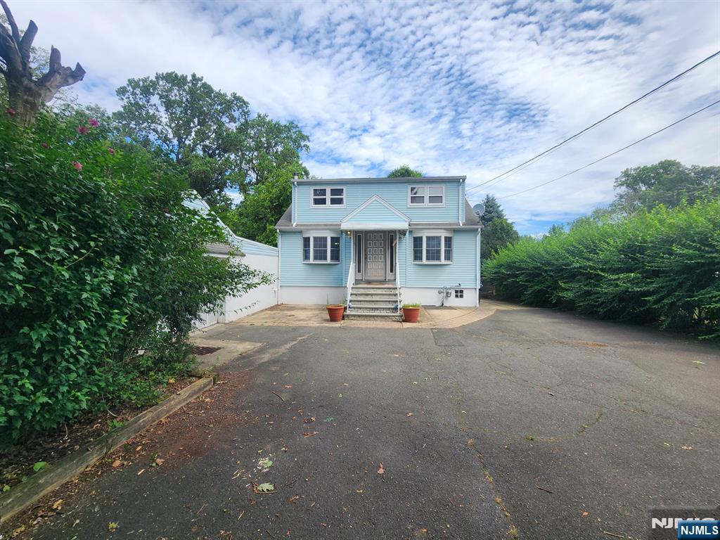 Tucked away on nearly 3/4 of an acre, this well-maintained Cape-style home offers rare seclusion and incredible potential. Freshly painted with refinished hardwood floors, this updated home offers a convenient first-floor bedroom and full bath - ideal for single-level living or guests. Enjoy summer days in your own backyard oasis with an in-ground pool, and take advantage of the oversized one-car garage with extra space for storage or a workshop. Quiet and peaceful, yet close to local amenities, this must-see property is full of charm and ready for your personal touch.