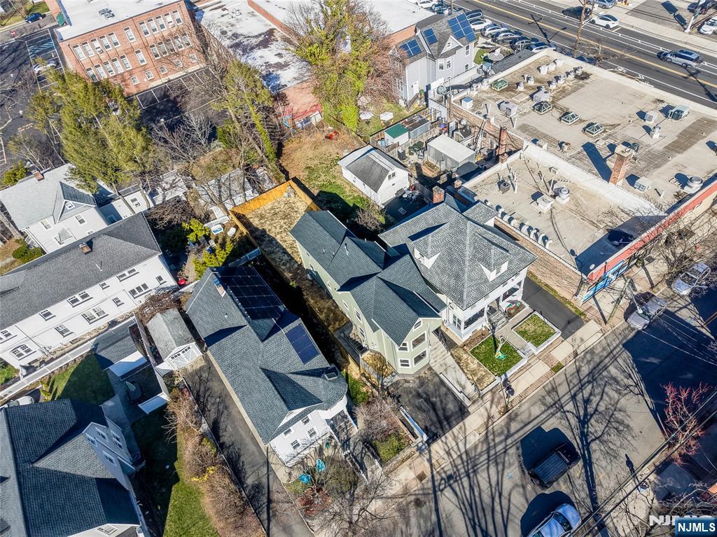 Welcome to refined living in the heart of Leonia. This fully renovated 5-bedroom home offers over 3,300 sqft of beautifully updated living space, combining modern design, flexibility, and exceptional commuter convenience. The open-concept layout seamlessly connects the living, dining, and kitchen areas, creating an ideal setting for everyday living and entertaining. Sun-filled interiors feature new hardwood flooring throughout the first and second levels, while major upgrades include a new roof, new siding, updated electrical system, dual-zone HVAC, and a professionally finished blacktop driveway. A sought-after first-floor primary suite with a private full bath provides flexibility for multigenerational living, guests, or a home office. Upstairs offers four spacious bedrooms, a full bath, and the convenience of second-floor laundry. The finished lower level expands the home's versatility with flexible space perfect for a recreation room, fitness area, media room, guest retreat, or office. Additional highlights include a dedicated office, second washer and dryer, and a wet bar with an L-shaped peninsula. Ideally located near schools, parks, shopping, dining, NJ Transit, major highways, and just minutes from the GW Bridge and NYC transportation. Move-in ready and thoughtfully updated, this is a rare opportunity to own a turnkey home offering space, style, and commuter convenience in one of Bergen County's most desirable communities.