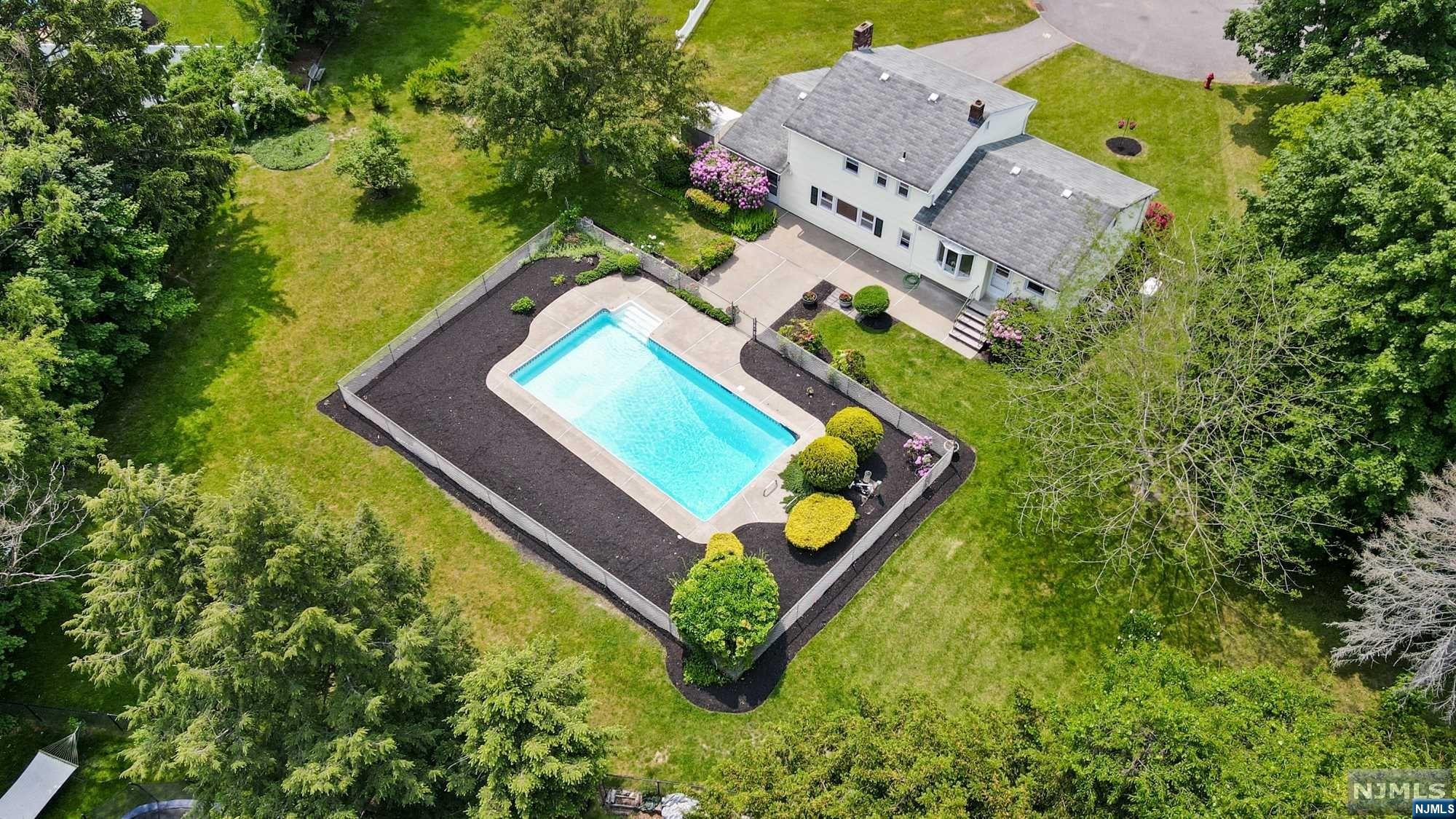 As you take a slow drive down this tranquil cul-de-sac in one of North Jersey's most prestigious communities you will simply say "I'm Home". Situated on nearly 1/2 acre of land, this home offers an exquisite blend of comfort, warmth, functionality & desirable amenities including a new whole-house natural-gas-fueled generator & central air. The main level features a spacious LR, perfect for relaxing or entertaining guests. Adjacent to the LR is a dining room which flows right into the eat-in kitchen where you can enjoy culinary creations while taking in the picturesque views of the private backyard. All 3 bedrooms are well-appointed & offer refinished Hd/Wd flooring while the master also includes a walk-in closet & private powder room. The ground floor family rm anchored by the brick fireplace is the perfect place for large gatherings. This property features an in-ground pool & sprawling yard space. Schedule a viewing & experience the best that North Jersey has to offer!