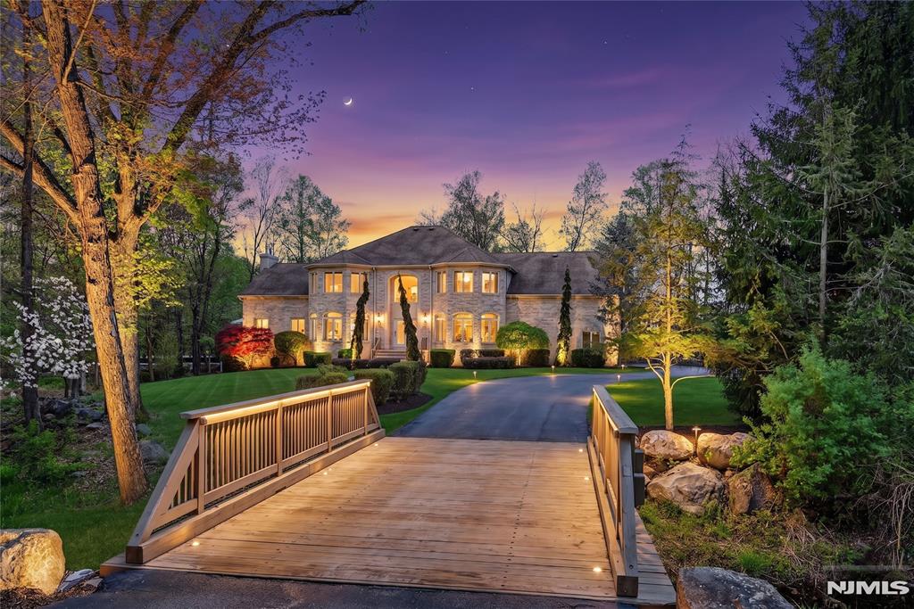 Set within Rio Vista, arguably Mahwahâ€™s most coveted neighborhood, this distinguished residence is privately positioned at the end of a cul-de-sac on 3.62 acres. A long approach reveals a stately brick-and-stucco facade framed by mature landscaping, elegant up-lighting, and a gentle brook enhancing the serene setting. Inside, a grand two-story foyer with sweeping staircase introduces a thoughtfully designed layout. The main level offers seamless flow for everyday living and entertaining, featuring a sunlit dining room, oversized living room with panoramic views, and a front-to-back great room with tray ceilings, hardwood floors, custom inlays, and a gas fireplace with marble surround. The kitchen is well-appointed with a 36" Viking range, center island, and maple cabinetry, opening to an expansive composite deck with modern cable railing, built-in gas fire table, and gas line for grilling. A first-floor bedroom with ensuite bath, plus laundry, powder room, and pantry, add flexibility. Upstairs, four bedrooms each offer ensuite baths; the primary suite includes tray ceiling, sitting area, dual walk-in closets, office/meditation room, and a spacious bath with soaking tub and walk-in shower. A full unfinished basement (~2,200 SF) with egress windows and two staircases offers endless potential. 3 Car Garage, four-zone HVAC system, 300-amp electrical service, most-of-house generator with automatic transfer switch, advanced water filtration systems and a view from every room!