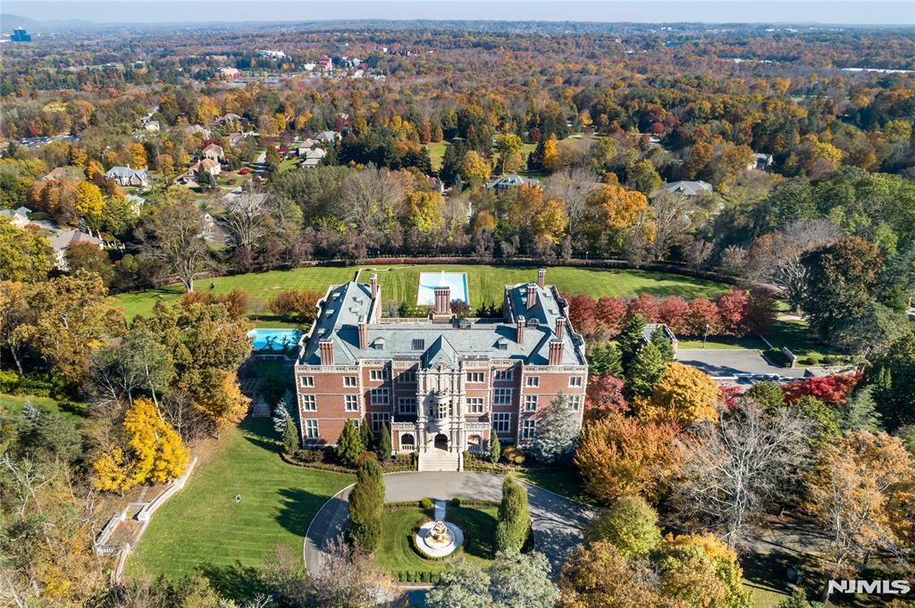 Welcome to the Crocker Mansion, a rare masterpiece 25 miles from New York City. Originally constructed in 1907, this historical estate has been meticulously restored, apprx 50,000 sq ft of spectacular living space, situated on 12+ acres & views of the picturesque Ramapo Mountains. This exceptional property boasts 21 luxurious BRs, 26 bathrms, rare woodwork, exquisite stonework, & unparalleled craftsmanship. The reception rms are grand, including a stunning Great Hall & library. Perfect for entertaining w/ a restaurant-style kitchen & prep kitchen. Leisure options abound w/ a billiard rm, game rm, wine rm & theater. With a focus on wellness, there is an indoor pool, spa, steam & sauna, massage rm, salon & gym. The outdoor amenities are impressive, w/a stunning pool, cabana, gardens, fountains, tennis ct, guest house, gate house & an 8-car garage. This one of a kind estate offers a lifestyle of unparalleled grandeur & comfort, come own a piece of history. Photos from previous listing.