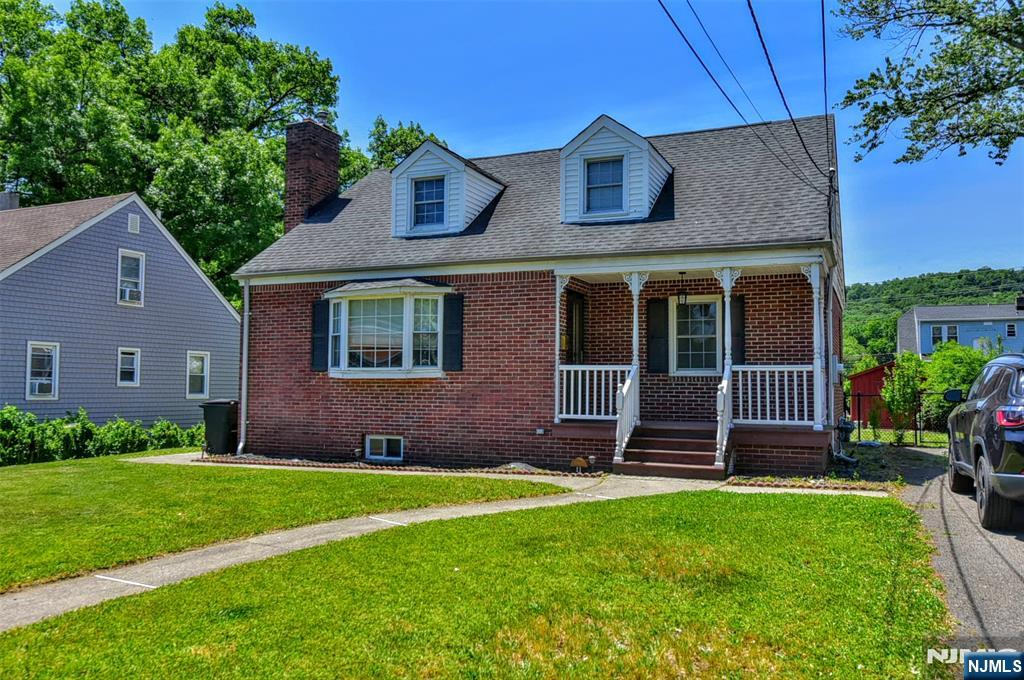 Welcome to this charming 3-bedroom Cape Cod nestled in desirable North Haledon. The first floor features a spacious living room, two comfortable bedrooms, a newly updated kitchen, and a renovated full bathroom. Hardwood floors run throughout the main level, offering timeless character and warmth. Upstairs, you'll find a generously sized third bedroom that provides privacy and flexibility for a primary suite, home office, or guest space. The large basement offers abundant storage and potential for future finishing. Other features include newer HVAC, including central AC, a welcoming front porch, and a rear patio overlooking the flat backyard. Conveniently located near schools, shopping, and transportation, this home combines classic charm with modern updates and is ready for its next owner to make it their own. Don't miss this wonderful opportunity to own a home in sought-after North Haledon :)