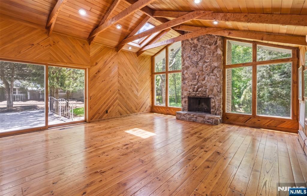 This Remarkable Home on the West side of Hillsdale New Jersey is a wonderful, Renovated & Expanded Center Hall Colonial set Majestically at the end of a long cul de sac. The Amazing Expansive & Immense 14' high Ceiling Great Room addition w/skylts, fpl, & wet bar leads to a deck to the West side, paver patio to the east, and the rear yard & protected wooded area. A 3 Year New Kitchen with granite counters, stainless appliances & beautiful cabinetry opens to the Great Room & Two Car Garage. You will enjoy the security of a house generator, sought after privacy, The Berkshires in New Jersey, & an elegant atmosphere inside & out. The Center hall Leads to The Dining Rm, Living Rm, Family Room and Powder Room, while the Renovated Kitchen Opens to the Immense & Grand Great Rm. The Primary Suite has a renovated Primary Bath, built in Cabinetry and many closets. The remaining 3 Bedrooms are very spacious, and a Main Bath is in the Hallway. This spacious home is for the buyer looking an extraordinary life style where contemporary meets mid century modern, & where folk art & sophistication are captured within the four walls of unique beauty! A landscape architect designed the stunning natural foliage, including a row of cryptomerias for privacy, Japanese maples, & numerous specimen plantings, PLUS sprinklers & landscape lighting! Close to the Express Bus to NYC & fine schools, this home offers an exceptional life style!