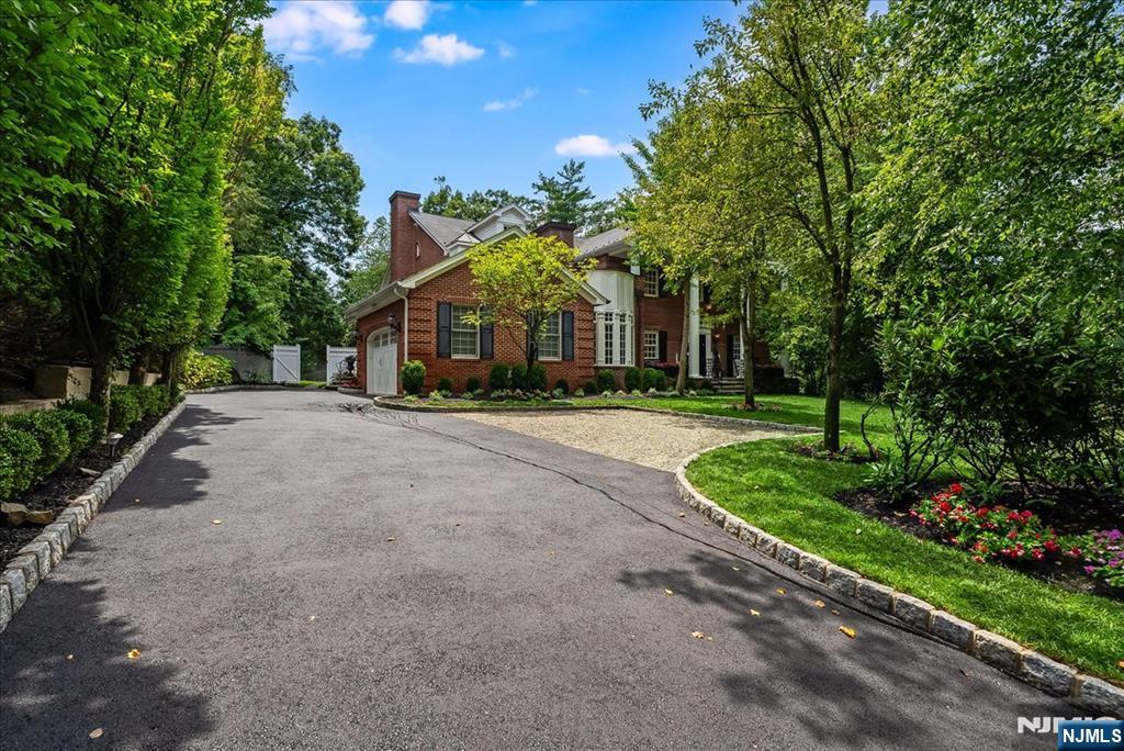 Welcome to " TARA ON THE EAST HILL", a stately all-brick Georgian Colonial is a rare gem. Set on a manicured nearly half-acre lot, it offers 6,200+ sq ft of exquisitely renovated living space across four finished levels. A sweeping staircase greets you in the grand entry, leading to elegant, light-filled rooms with custom millwork, barrel, tray, and vaulted ceilings. French doors from the Great Room and den invite seamless indoor-outdoor living. No expense spared! The chefâ€™s kitchen is the heart of the homeâ€”complete with two oversized islands, a butlerâ€™s pantry, 2 sinks, 3 dishwashers, & top-tier appliancesâ€”designed for entertaining & everyday ease. Formal & informal spaces include a wood-burning LR fireplace, richly paneled library with private entrance, and expansive dining room. Retreat upstairs to a luxurious primary suite with spa-like his & hers baths, walk-in closets, and private terrace. A second suite, Jack-and-Jill bedrooms, and third-floor bedrooms offer flexible living. The finished lower level includes large rec rooms, full bathroom, storage, home office with yard access, and laundry. 2nd staircase. Dual heating systems throughout the home (Radiant heat, steam radiators, and zoned HVAC) ensure year-round comfort. Just 10 miles from Manhattan, near top schools, worship, and downtown Englewood. Walk to worship, shopping, parks& transportation. A home of craftsmanship, character, and modern luxuryâ€”this one must be seen.