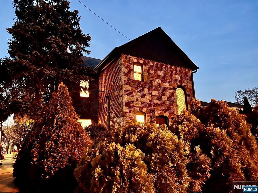 Large Charming Historic Home on the border of Fort Lee, Cliffside Park, and Edgewater. Inviting foyer with stained glass and sunken living room. This large 4 bedroom plus den, 4.5 bath house is located 1 block to NYC transportation and minutes from George Washington Bridge. Perfect for NYC Commuters or an expanding family. The home features vintage stone exterior with a solid front wood door. Newly finished hard wood floors throughout the home, original tile and a large kitchen with separate dining room. This unique home features include outdoor terrace and sunroom, full finished basement with bar, Russian sauna, bathrooms with large soaking tubs, cedar closets, plenty of storage space, backyard, Washer/Dryer and more. Property also features a large spacious 2 car garage with additional workshop space.