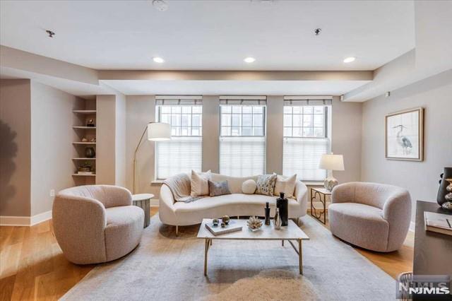 Welcome to The Crossings in Hoboken, where you'll find this bright and airy over-sized garden level 3-bedroom, 2-bathroom unit in a private corner location with southeastern exposure with optional dedicated covered SUV-sized garage parking. The unit is 1640 sq. ft. of well-designed living space, featuring an open layout with a modern kitchen equipped with a suite of stainless-steel appliances, quartz countertops, and a breakfast bar. Enjoy recessed lighting, white oak hardwood floors, central A/C (Ecobee smart thermostat), oversized bedrooms, 11 closets (including one primary bedroom walk-in closet and a walk-in pantry) that provide generous storage, well-appointed bathrooms with imported marble and porcelain tiles, and abundant natural light pouring in through oversized windows throughout the unit. New hot water tank (2024) and new HVAC (2022)! In-unit LG washer / dryer. The building features sturdy steel and concrete construction, along with an elevator for added convenience. For commuters, there's easy access to transportation options with a bus stop to NYCâ€™s Port Authority right outside the front door (door-to-door in ~20 minutes), and close proximity to the Ferry and bus routes to PATH train stations. Enjoy the convenience of being seconds away from local Hoboken schools, nearby shopping options like Trader Joe's (3 blocks) and Shoprite, as well as a variety of cafes, restaurants, and parks within walking distance including renowned Columbus Park (1 block away).