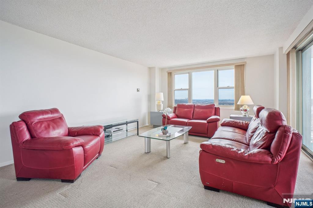 Welcome home to the largest 2-bedroom, 2-full-bathroom corner unit in the building. There is a gracious foyer, a walk-in closet, a galley kitchen, a full formal dining room, and a large living room with sliders to your terrace. Primary bedroom ensuite with 2 closets, and hall bedroom, hall full bathroom. The views are absolutely breathtaking--east, south, and west-with a sunny apartment all day long. Luxury co-op includes all utilities in maintenance and uniformed doorman, gym, basketball, tennis, and pickleball. The NJ Transit bus 158 is at the door, and parking is $60.00 for inside parking or $55.00 for outside parking. The building is wired for Spectrum or Fios. Real estate taxes, electricity, and utilities are included in monthly maintenance. Outdoor olympic-sized pool membership and a very social lifestyle with a Tiki Hut all summer at the pool.