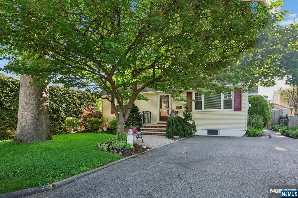 Charming cape with in-law suite potential. First floor -MEIK-Living room-2 bedrooms, full bath. Second floor MEIK Living room-2 bedrooms-full bath with separate entrance. Basement-Den-Exercise room/play room- 1/2 bath- additional storage with separate entrance. Beautiful backyard with park-like setting with covered patio with hot tub. Large storage shed. Near NY transportation.