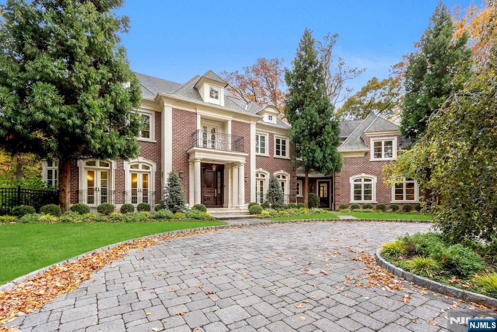 A private, 200-foot driveway gracefully ascends to an all-brick Colonial residence, masterfully designed by renowned architect James Paragano. Set majestically on 1.43 acres of lush, meticulously landscaped grounds, this distinguished estate blends timeless elegance with modern luxury. The grand first level showcases soaring ceilings and five principal reception rooms, including a richly appointed mahogany library with fireplace, an elegant formal dining room, a gracious living room with a fireplace, a warm and inviting family room with a fireplace, and a striking front-to-back open foyer that bathes the home in natural light. Upstairs, five exquisite bedroom suites offer refined comfort, highlighted by a sumptuous primary suite with serene views of the surrounding landscape. Together, the first and second floors provide approximately 7,000 square feet of sophisticated living space. The fully finished lower level extends the homeâ€™s versatility with a spacious playroom, a kitchenette, a media room, an exercise room, and another bedroom with a full bath. Completing this exceptional property is an oversized three-car garage on the main level and a spectacular oversized resort-style pool with spa, creating an idyllic setting for both relaxation and entertaining.