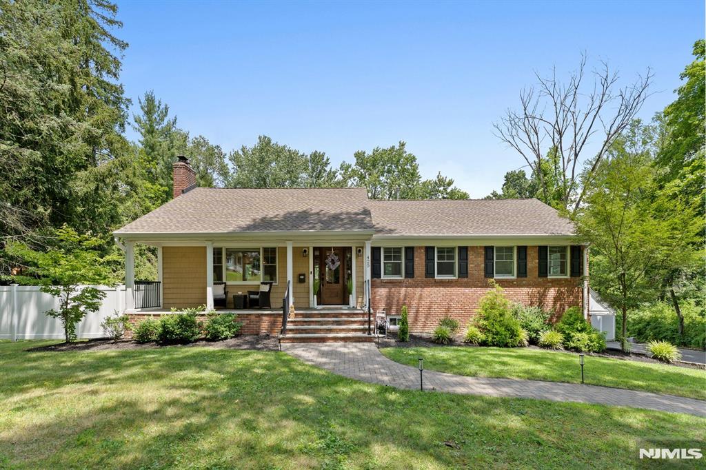 Stunning 3-bedroom, 2-bath ranch on nearly three quarters of an acre in desirable Wyckoff! This beautifully updated home features a welcoming foyer, spacious living room with fireplace, and a custom chef's kitchen with oversized island, quartz counters, and high-end appliances. Two bedrooms share a stylish full bath, while the primary suite includes a large walk-in closet, oversized stall shower, and access to a rear bluestone balcony. Hardwood floors run throughout the main level. The finished lower level offers a large family room, laundry, storage/mechanical room, and mudroom entry from the attached 2-car garage. Updates include newer roof, windows, siding, leaf-guard gutters, driveway. Relax on your front porch or head to the back to the fully fenced yard. This space is ideal for entertaining with a large patio and in-ground salt water gunite pool. Additional features include LED recessed lighting, security system, newer pool heater, and more. Move-in ready and perfect for indoor/outdoor living-don't miss this one!