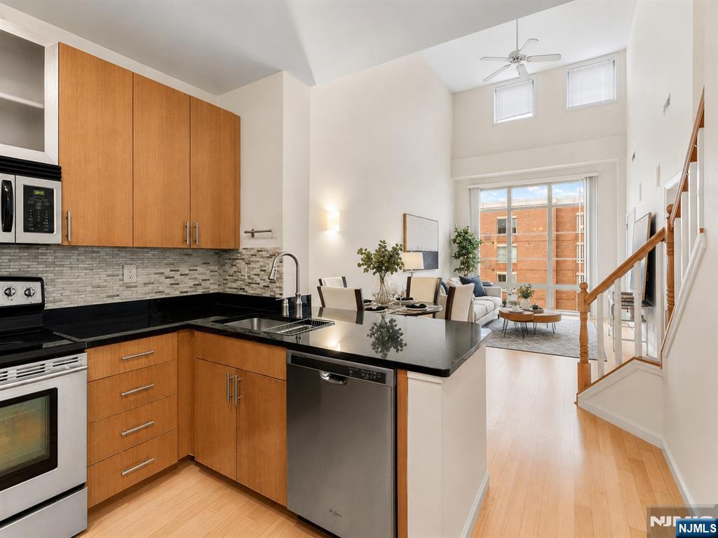 Experience the space and flexibility of this beautifully renovated 2-bedroom plus den, 2-bath residence in the highly sought-after Hudson Club community. Offering approximately 1,134sqft, this bright and inviting home features NYC and Hudson River views, an open-concept layout, soaring vaulted ceilings, and dramatic floor-to-ceiling windows that fill the living space with natural light. The chef's kitchen with SS appliances, granite countertops, and generous cabinetry, opening seamlessly to the spacious living and dining areas for effortless everyday living and entertaining. The primary suite includes a walk-in closet and renovated en-suite bath, while the spacious second bedroom offers excellent closet space and convenient access to another beautifully updated full bathroom. A custom loft provides valuable bonus space that can function as a home office, den, or additional storage. Enjoy an in-unit W/D and 1 indoor parking. The monthly HOA fee includes water, hot water, parking, amenities, and cable/internet. Residents enjoy resort-style amenities including concierge service, an outdoor pool and jacuzzi, fitness center, basketball court, cinema room, social lounge, business center, fire pits, and more. Ideally located near ACME, Paris Baguette, waterfront dining and shopping, the NY Waterway Ferry, Hudson-Bergen Light Rail, and NJ Transit bus service, this home offers the space, convenience, and lifestyle todayâ€™s buyers are looking for all within easy reach of Manhattan.