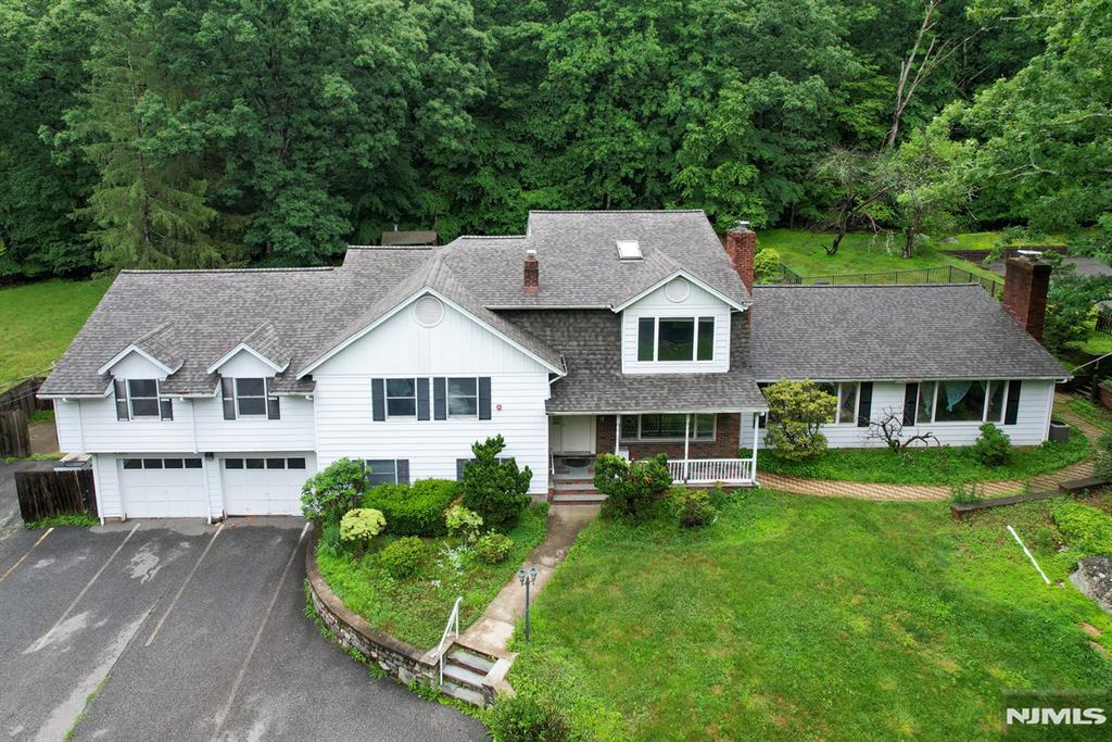 This expansive custom split level home, with estate-like privacy, offers appr 5000 sq ft of living space, beginning with a welcoming front covered porch that leads into a spacious entrance foyer. The main level features multiple gathering areas, including living room/fireplace, great room w/fireplace, dining room & large kitchen with dining area provides excellent flow for everyday living. 2nd & 3rd Level offers 7 bedrooms and 4.5 baths, offering exceptional flexibility for large or multi-generational households. An attached oversized 2 car garage provides ample parking and storage. The semi-finished basement offers additional space along with large storage areas and room for future customization. Outdoor amenities include a built-in pool with a pool shed, patio, nice size yard that backs to the wooded state lands. The property also features a Carriage House (3,740 sq ft) with flexible uses studio, office, gym, storage, hobbies, or workspace. Can be converted back to a large 2 car garage for antique cars, collectors or gardeners. Features include a sprinkler system, 6 zone heating system, safety and mechanical features throughout the home, new roof in 2026 and a newer septic system. This is an opportunity to own a substantial property with extensive living. Can Be Used As A Group Home With The Extra Structure As An Activity Center. space, valuable upgrades, and multiple functional structures. The home is in need of repair and is being sold in "as is" condition.