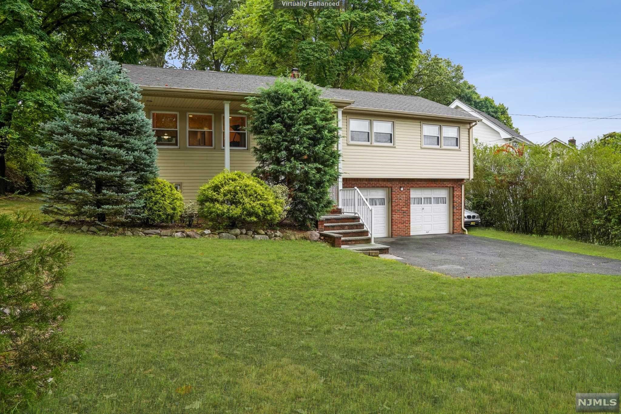 Welcome to this meticulously maintained, expanded bi-level on a park-like setting in the heart of Glen Rock. Updated & expanded this sun drenched 4 bedroom, 3 full bath home offers a classic floor plan w/over 2500 sqft. Includes a formal living & dining rooms, a spacious family room w/cathedral ceilings. The fabulous chef's kitchen is a dream w/granite counters, commercial grade exhaust, & looks out to nature's paradise w/access to oversized deck. 3 bedrooms including a Master suite w/double closet & full bath/jacuzzi tub. Hallway bath inc jacuzzi tub. Fully finished grade level inc add'l bedroom, full bath, family room w/access to patio, bonus room adding add'l space for extended family and plenty of room to entertain. Direct access to a 2 car garage. Set on a .3 acre property w/mature plantings! Amenities inc gleaming hardwood floors, recessed lighting throughout, new hot water heater & full attic storage. Leave your car behind & enjoy all that Glen Rock has to offer! Must see