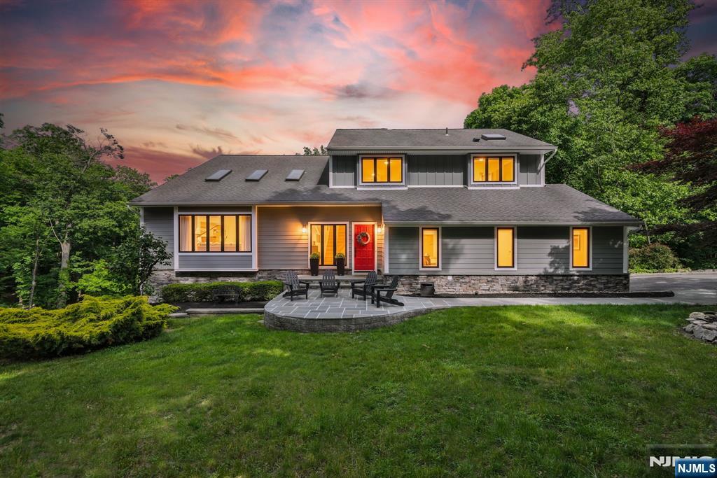 Nestled on nearly 2 private acres within the prestigious gated community of Smoke Rise, this exceptional custom residence showcases luxury, craftsmanship, and meticulous attention to detail throughout. This 4-bedroom, 3.1-bath home seamlessly blends timeless design with modern comfort. Extensively renovated with uncompromising quality, it features premium Hardie siding, expansive two-level Trex decking, radiant-heated floors in the primary bath, vaulted ceilings, custom millwork, professionally curated finishes, and beautifully landscaped grounds. Every improvement has been thoughtfully executed, creating a truly turnkey luxury residence. Designed for both entertaining and everyday living, the home is filled with natural light and offers exceptional flexibility. The walkout lower level features soaring 12-foot ceilings, direct access to the outdoor living areas, a private office or flex room, and a separate en-suite guest suite ideal for a fifth bedroom suite. Additional highlights include a custom garage with built-in cabinetry, epoxy flooring, and cathedral ceilings with ample height for a vehicle lift. Surrounded by the privacy, security, and natural beauty that define Smoke Rise, this one-of-a-kind residence offers a rare opportunity to own a meticulously updated home where luxury, functionality, and lifestyle come together effortlessly.