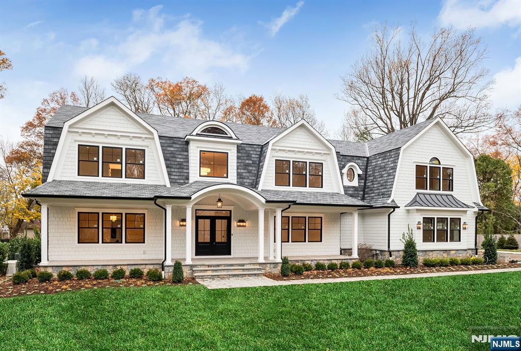 Stunning NEW construction Hampton style home located on the East Hill of Upper Saddle River is the epitome of luxury. This custom-built masterpiece by high end builder showcases 7,961 sq ft on 3 levels. Gorgeous exterior w/ covered front porch, sweeping roof lines & large level property. Enter to a 2 story EF w/ wide plank white oak floors, banquet size DR w/cstm clg, large LR w/panel walls. Dream designer kitchen w/ breakfast rm with all the amenities, custom island, high end appliances, built-in coffee bar, opens to outdoor living space w/raised 36' x18' bluestone patio w/outdoor kitch & FP. 2-story great rm w/ vaulted ceiling, custom beams & FP opens to patio. First fl BR, full bath, pantry, butler pantry, powder rm, & built-in mudroom area w/ access to 3-car garage w/ EV charger complete the 1st level. The second level offers 5 large BRs, 3 en-suite, 2 Jack & Jill, office, & laundry rm. The primary suite is a masterpiece w/ vaulted ceiling showcasing custom beams, FP, 2 WICs, & luxurious bath w/ oversized marble shower, dual vanity & soaking tub. The finished lower lvl offers a 7th BR, full bath, gym, theater, rec area, kitchen, & 2nd laundry rm. CAT5 cables all BRs, gym, theater, office, & great rm. Movie rm w/ 120 in. retractable acoustic weave screen, projector w/ wall speaker subwoofers & data tower. Security w/ 16 port w/ 9 cameras. Prewired for 6 Wifi hotspots. Wired speakers and dedicated amps to kitch, back patio & gym. 26 KW generator. Truly exceptional!