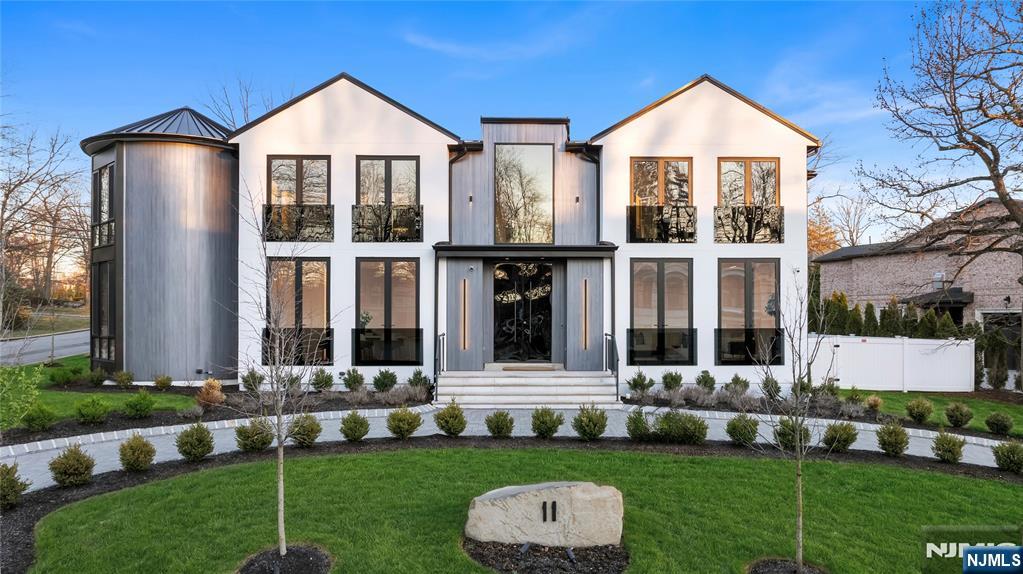 Located on Roberts Road, one of Englewood Cliffsâ€™ premier streets, this new construction, metal roof 7-bedroom, 8.1 bath residence sits on 0.47 acres and offers approximately 11,500 square feet across 3 elevator-serviced levels. The main level features an open living space w/ fireplace and a full-width folding glass wall system that fully opens to the patio and pool. The kitchen is finished with custom high-gloss cabinetry, full slab stone with bookmatched detailing, a Sub-Zero and Wolf appliance suite, walk-in pantry, mudroom, office, 1st-floor bedroom suite, powder room, laundry w/ sink and built-ins, and a full bath serving the pool. Upstairs, the primary suite offers a sitting area, fireplace, beverage bar, balcony access, custom closets, bath w/ soaking tub, glass-enclosed shower, and towel warmer. A junior suite includes its own sitting area, beverage bar, and dual double-door openings for ventilation. Three additional bedrooms are all en-suite with custom closets. The fully finished lower level includes a theater with fully reclining massage seating, bar, recreation space, ~550 bottle wine room, additional bedroom, and full bath. Outdoor features include a heated gunite pool with waterfall, custom Walpole grilling station, pergola with adjustable roof, and anti-slip stone patio. A 3 car heated garage with EV provision, whole-house generator, metal roof, smart home system + irrigation, Sonos, and multi-zone heating & cooling with radiant heat complete the home.