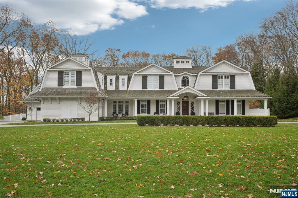 Perfectly nestled on just under two acres and set far down a private driveway, 128 Birch Road offers a rare blend of luxury, elegance, and relaxed sophistication. Located at an exclusive setting that prioritizes privacy, this premium (6BR,10 BATH) custom-built home welcomes you with refined craftsmanship and effortless flow. Wrapped in classic cedar shingles, the residence showcases exquisite custom woodwork, soaring 10ft ceilings, and radiant heat throughout. Step into luxury where even the staircase stands as a work of art. Majastic 2-story foyer flows seamlessly into the great room beautifully appointed with coffered ceilings, intricate millwork, fireplace, glass doors opening to the rear bluestone patio. Beautiful Chef's kitchen features a large center island, premium appliances and an expansive dining area with walls of glass that frames views of the outdoor space.The primary suite is your personal sanctuary with a walk-in closets and spa-like bathroom. The lower level offers a wealth of amenities, including media rm, recreation rm with custom built bar, play area, exercise studio and access to professionally designed paradise featuring breathtaking pool with hut tub and waterfall. Sunlight spills across the back of the house, where the generous covered patio blurs the line between indoors and out. A stylish cabana with a warm fireplace creates a cozy focal point. Five car garage, golf simulator room and much more...
