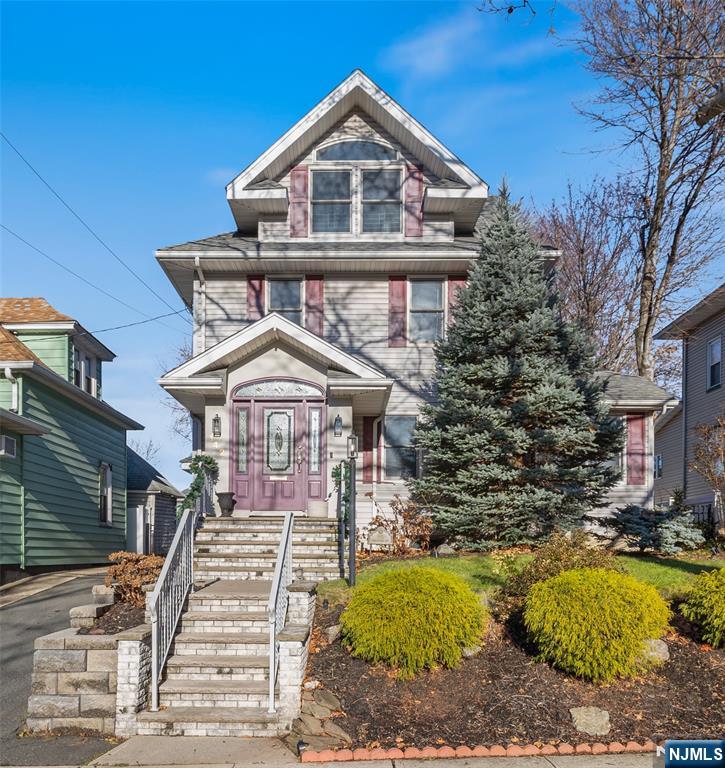 Meticulously maintained and tastefully updated, this classic side-hall colonial sits in a centrally located neighborhood. The first floor begins with a welcoming mudroom entrance that leads to a spacious Living Room, formal Dining Room, and a custom Kitchen with island and top-of-the-line appliances. A versatile den/guest suite offers seamless access to the large rear deck and overlooks the perfect yard. The second floor offers a Primary Bedroom with ensuite bath, walk-in closet, and a stunning built-in wall unit, along with two additional Bedrooms and a Full Bath. The third floor includes two bright Bedrooms and a half bath. A full basement with laundry room and storage. Step outside to the large, deep, and beautifully designed outdoor space featuring professional turf with no maintenance required. Fenced in yard, deck, sprinklers, alarm systems and detached 1 car garage. Perfectly situated within blocks of schools, parks, shopping, and transportation.