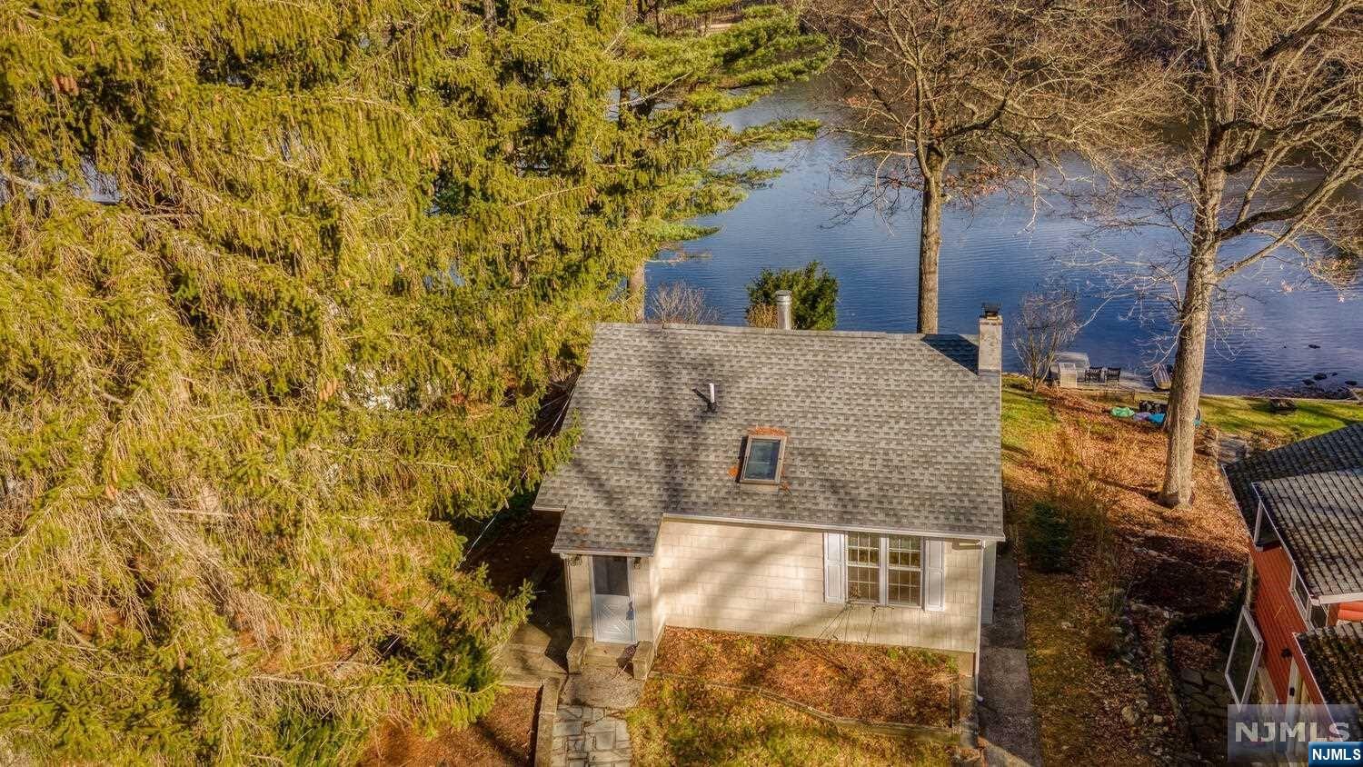Ranch style charmer on a private lake close to most everything north and south. Over a half acre wonderfully suited for either full time or vacation lake living. The deep back yard and walkway slope gently down to the dock and lake overlooking the community beach and clubhouse across the way. Enjoy sunrises from the back deck in warmer weather or looking out to a winter wonderland from the den with sliding glass doors to the deck. A walkout basement with half bath has the laundry hook up and plenty of room for water and outdoor recreation toys. Enjoy swimming, kayaking, paddle boarding, fishing (electric motors only) and ice skating in the winter from your own private lakefront gem. The interior photos are from before the long time tenant moved out, home is now vacant and unfurnished.