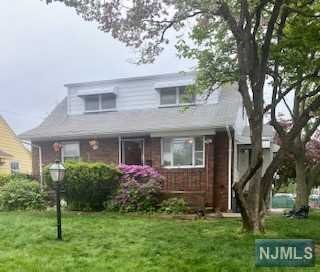 This 4 bedroom, 2 full bath expanded cape is in the Hillcrest section of Paterson, and is less than 2 blocks from the Totowa border. There is a large open living room/dining room. The eat-in kitchen is large and functional, but can use updating. In additon to a one-car attached garage(with electronic opener), there is a garage sized separate structure with windows all around that the current owner calls "the summer house", and could easily be repurposed as a stidio, a workshop, a gym, or extra storage. The basement is finished with a built-in bar and a 2nd kitchen. The porch, which spans the front of the house, is waiting for a pair of rocking chairs and a pitcher of lemonade. This property is not in a flood zone.