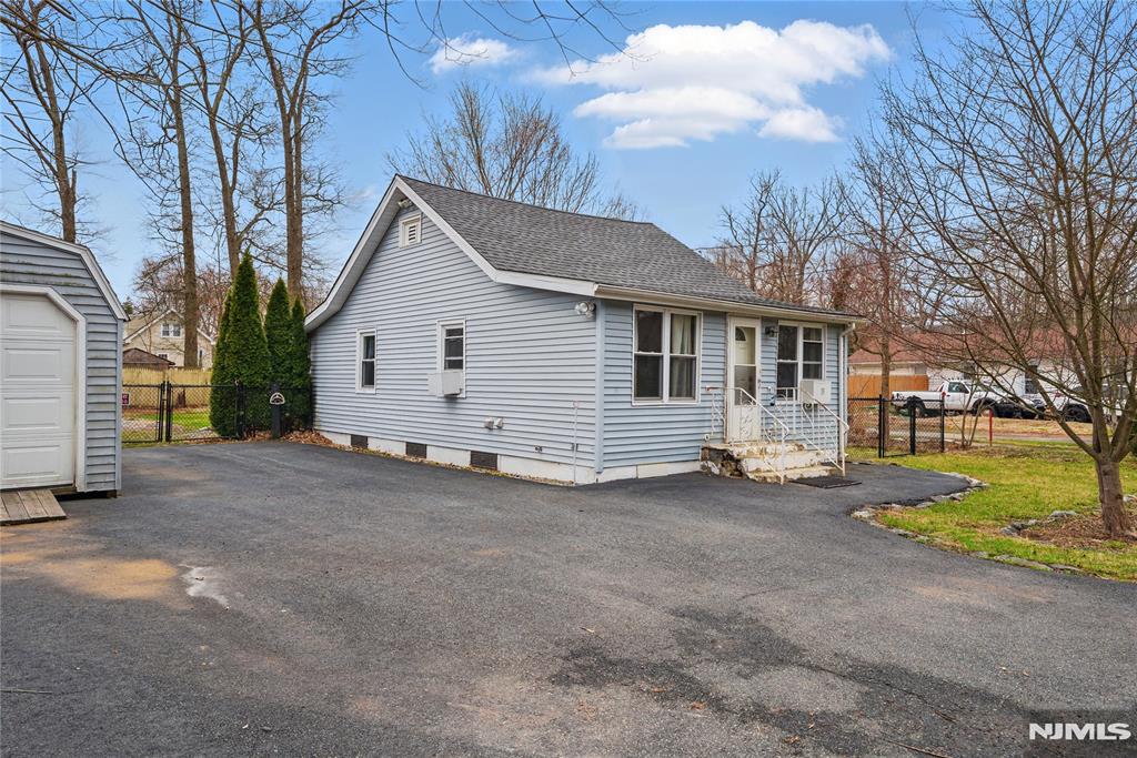 Welcome home, where charm & opportunity meet in this 700+ square foot home. Perfectly situated near Greenwood Lake & South Shore Marina, this property is an ideal choice for those seeking a peaceful weekend escape or a cozy year-round residence.This thoughtfully designed home offers a bright EIK, a comfortable living room, & 1 oversized bedroom originally 2 separate bedrooms complete with a WIC & convenient laundry. The layout maximizes space while maintaining a warm, welcoming feel.Enjoy outdoor living with both a covered front porch & a spacious back porch to a level, fenced-in yard perfect for entertaining, gardening, or relaxing in the fresh air. Also includes 2 storage sheds & a detached garage, providing ample space. Located near local shops, parks, riding paths, & everyday amenities, this property blends comfort, function, & a fantastic location.Don't miss this opportunity to own a charming slice of WM with access to some of the area's best outdoor recreation.
