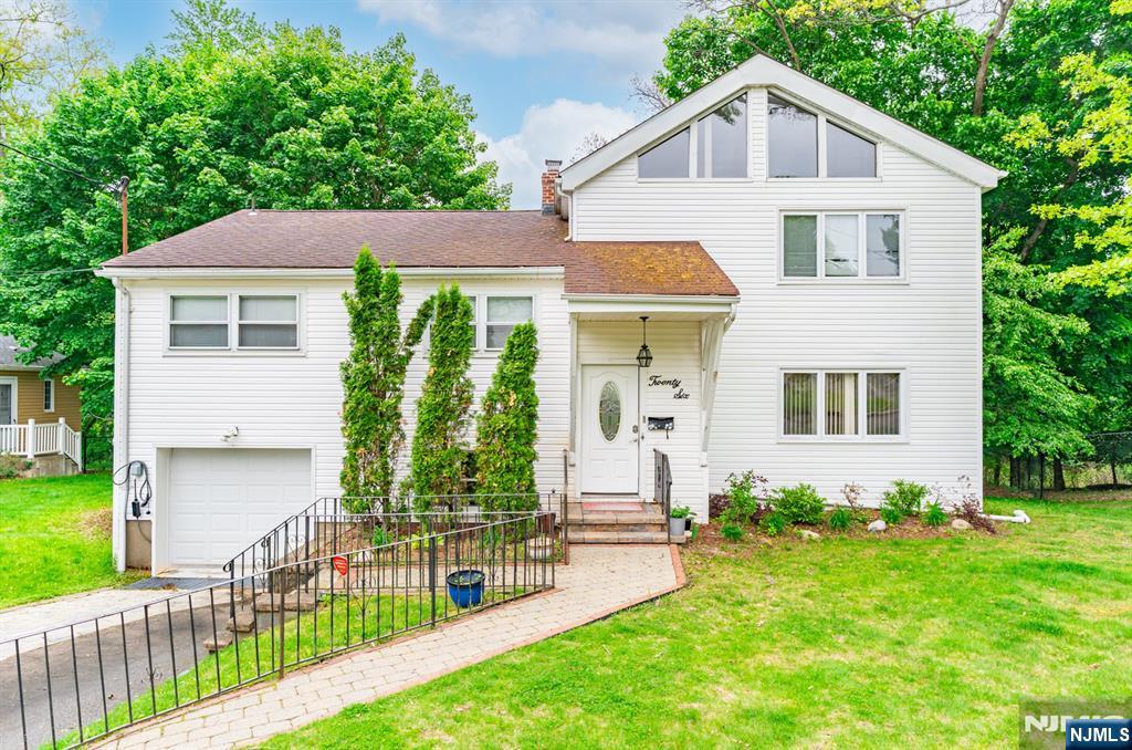 Welcome to 26 Cornell Street, a beautifully updated custom split-level in West Orange's coveted St. Cloud section. With over 2,700 square feet, 4 bedrooms, and 3 baths, this home pairs classic character with smart, modern upgrades. The layout flows effortlessly between everyday comfort and entertaining. Sun-filled living with the pool in the backyard, an updated kitchen built for both prep and gathering, and a natural transition to the backyard create a home that works as hard as it lives well. Upstairs, the oversized primary suite is a true retreat: vaulted ceilings, a private sitting area, walk-in closet, and spa-inspired bath. Outside, professionally landscaped grounds frame an in-ground pool and generous open space, striking the right balance of privacy and usability. Come turn this house into a home before someone else does