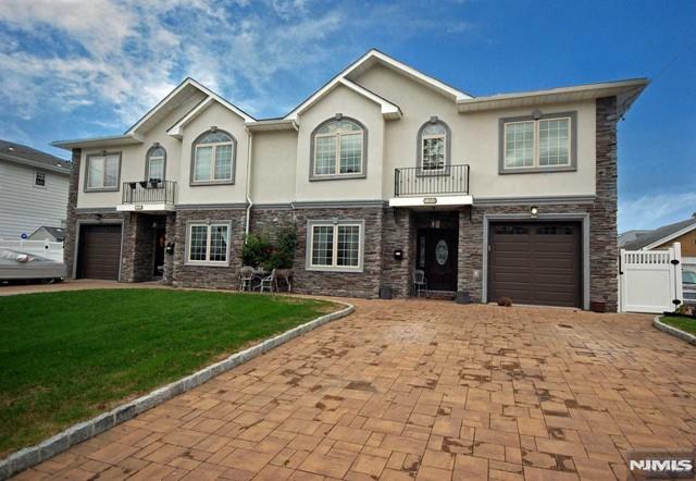 THIS CUSTOM BUILT, OVERSIZED DUPLEX IS LIKE NOTHING ELSE ON THE MARKET. BUILT BRAND NEW APPROX 8 YEARS AGO ON OVERSIZED LOT ON HASBROUCK HEIGHTS BOARDER. 1ST FLOOR FEATURES LIVING ROOM WITH FIREPLACE, EAT IN KITCHEN WITH CENTER ISLAND, DINING ROOM, BEDROOM, LAUNDRY AND FULL BATH. 2ND FLOOR HAS A MASTER BEDROOM SUITE FIT FOR A ROYALTY WITH CUSTOM BATHROOM, WALK IN CLOSET AND BALCONY. 2 MORE LARGE BEDROOMS AND FULL BATH FINISH OFF 2ND FLOOR. OTHER AMENITIES INCLUDE MASONRY STUCCO AND STONE, HARDWOOD FLOORS, CUSTOM KITCHEN WITH HIGH END APPLIANCES, CUSTOM BATHROOMS, SECURITY SYSTEM, PAVER DRIVEWAY AND PATIO WITH PERGOLA AND MORE!! PICTURES DON'T DO THIS HOUSE JUSTICE YOU MUST SEE TO BELIEVE!! NOT YOUR AVERAGE DUPLEX BUILT ON 100 X 100 LOT MAKING THIS UNIT ONE OF A KIND!!
