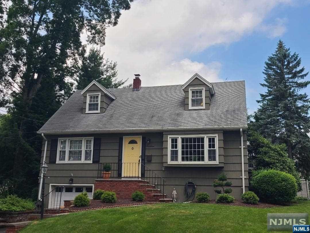 Prime location in much sought after Waldwick! Updated 4BR, 2BA Cape with gorgeous family room addition with brick fireplace/mantle leading to deck and fully fenced backyard. Hardwood floors, updated white kitchen cabinetry with granite counters/peninsula open to dining area and family room. A/C condenser 2018, water heater 2021, landscaping 2023 (lovely curb appeal). Plenty of sunlight from bow window into LR -- great for all your plants! Oversized garage has plenty of storage and leads to partially finished basement with laundry and huge walk-in closet. Sprinkler system takes the guess out of keeping that lawn lush and green.