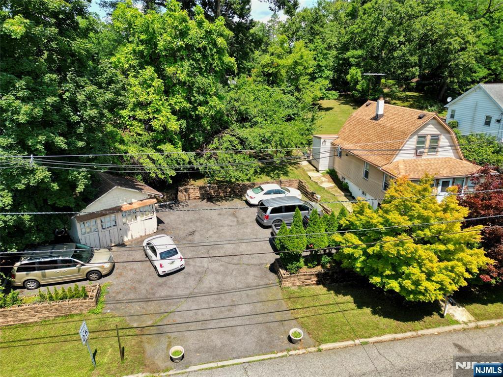 Great opportunity in North Haledon! This charming 3-bedroom, 1-bath Colonial with a detached garage is packed with potential and features a thoughtful layout across every floor. Highlights include a light-and-bright living room, a generous eat-in kitchen with great counter space, and an inviting sunroom perfect for dining or relaxing. The main floor features a spacious bedroom and full bath, while the upper level hosts two additional roomy bedrooms plus extra storage space. An expansive full basement offers tremendous storage or future living space potential. Set on a large, lush lot with plenty of parking, this home puts you minutes from High Mountain Park Preserve, Goffle Brook Park, Hofstra Park, local shopping, and easy transportation routes. Don't miss this one! PHOTOS ARE COMING SOON!