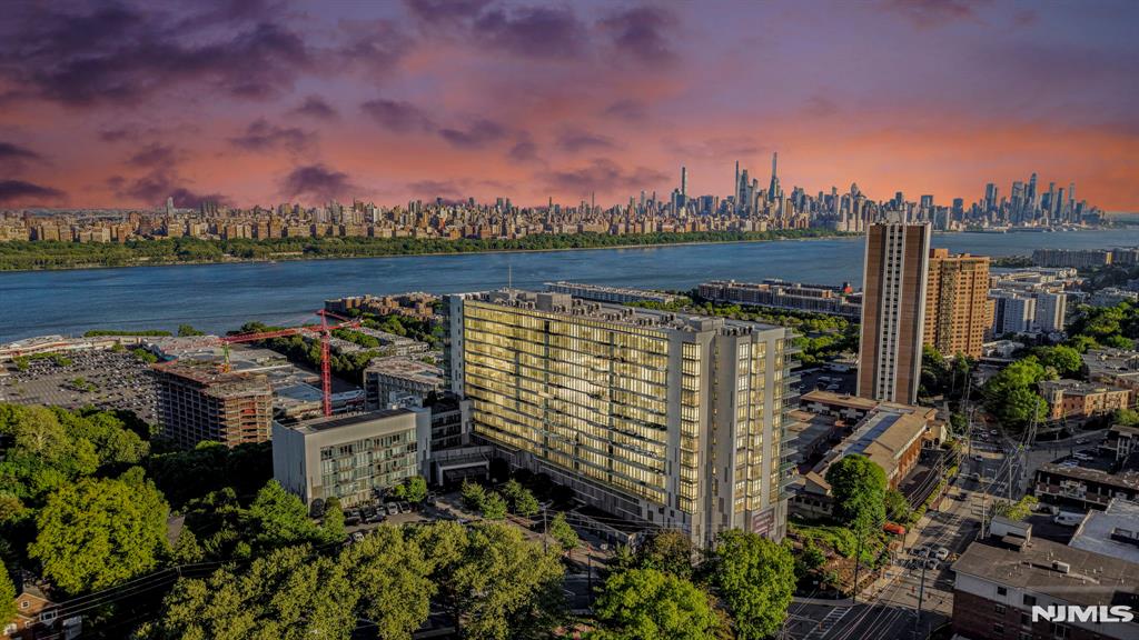 Experience luxury living at One Park in Cliffside Park, a 5-star luxury condominium offering breathtaking Hudson River and NYC skyline views. This stunning east-facing 3-bedroom residence features floor-to-ceiling windows, a modern Italian-inspired kitchen, spa-like bathrooms, smart-home wiring, in-unit laundry, and abundant storage throughout. Residents enjoy over 25,000 square feet of world-class amenities, including an indoor pool, state-of-the-art fitness center, sauna, yoga studio, golf simulator, media and billiards rooms, guest suites, outdoor entertainment areas, and more. Conveniently located near shopping, dining, major highways, and NYC transportation, this exceptional home delivers the ultimate blend of luxury, comfort, and convenience in one of the Gold Coast's premier addresses.