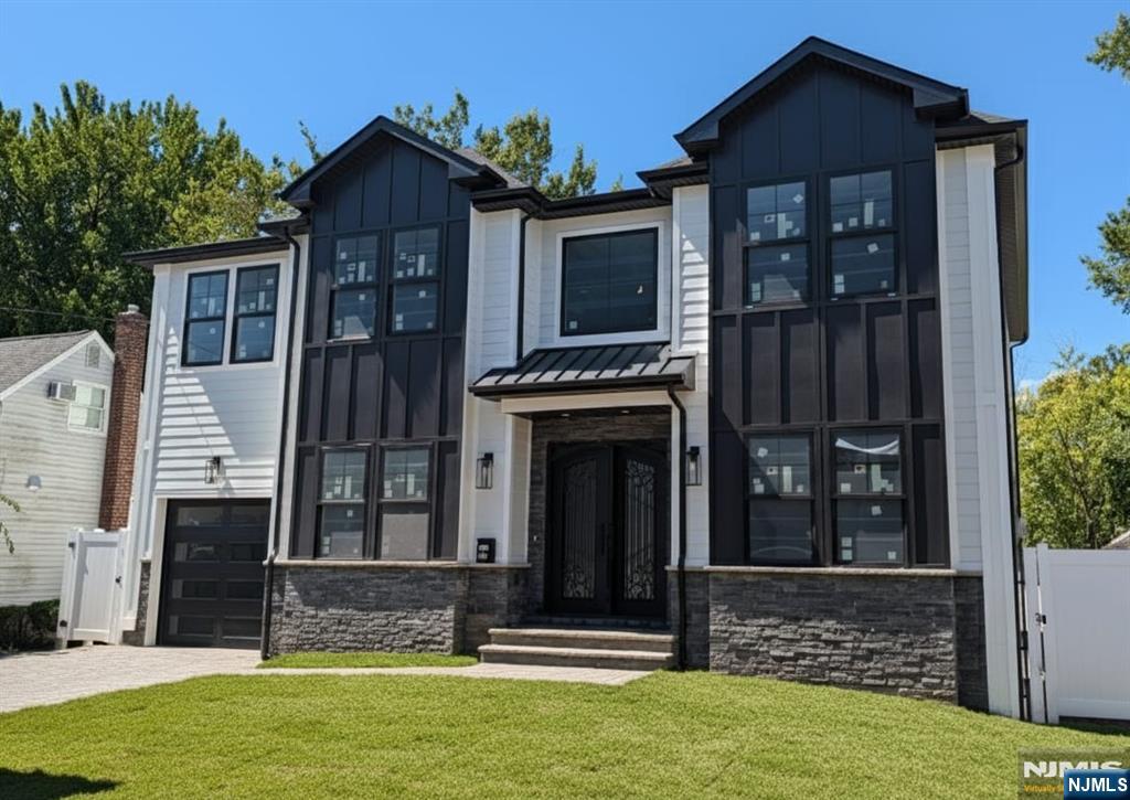 Stunning new construction home in desirable Bergenfield location. 10 foot ceilings on the first floor. Formal living room or study, formal dining room with washing sink and built in cabinetry. Kitchen with two sinks, two dishwashers, three ovens, a walk in pantry and a massive island. Family room with gas fireplace and a powder room complete this floor. Upstairs you will find the primary suite with two walk in closets, two junior suites, two additional bedrooms, a full bathroom and laundry. The basement has a large rec room with a wet bar, two spacious bedrooms and a full bathroom. The backyard is fully fenced in. 3 zone heat, 2 zone AC. Whole house generator and underground sprinklers. Close to houses of worship and parks. (Exterior photo has been virtually enhanced while work is being completed)