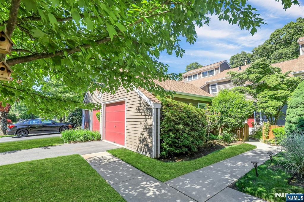 **For a private showing call Gary Silberstein at 201-647-4225.** Welcome to desirable Ramapo Ridge! This beautifully maintained three-level townhouse offers comfort, privacy, and convenience. The main level features an eat-in kitchen, dining room, full bath, and spacious bedroom with access to a front-facing patio. The sunken living room showcases soaring ceilings, a wood-burning fireplace, and sliding glass doors leading to a private deck overlooking serene woodlands. The upper level is dedicated to a private primary suite, complete with a loft ideal for a sitting area, reading nook, or home office. The spacious primary suite offers ample closet space and a full bath. The finished walkout lower level features a large recreation room, a separate bonus room ideal for a home office, den, guest room, or possible third bedroom, plus a laundry area and abundant storage. Sliding glass doors provide access to an additional outdoor living area. Additional features include a one-car garage with EV charger, central vacuum, newer heating and air conditioning, and newer appliances. Enjoy resort-style amenities including a clubhouse, fitness center, swimming pool, pickleball and tennis courts, basketball court, and playground. Conveniently located near top-rated Mahwah schools, shopping, dining, major transportation routes, and popular outdoor destinations including Darlington County Park, Ramapo Valley County Reservation, and Campgaw Mountain Reservation.