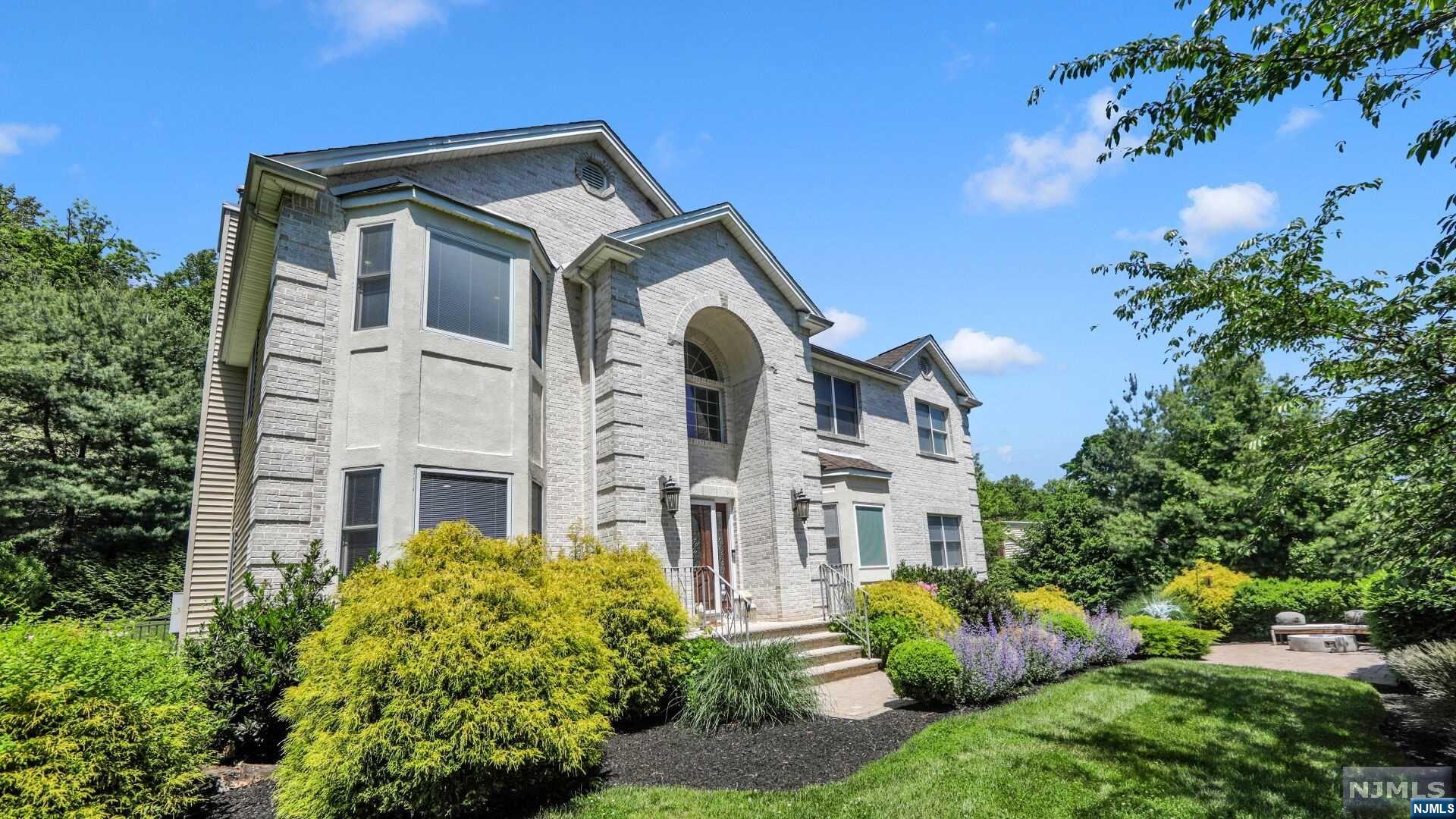 Welcome to this exquisite Cedar Knolls gem, ready for you to move in. This custom-built, smart Colonial home features 5 bedrooms and 3.5 bathrooms, nestled on a serene cul-de-sac. Experience luxury living with upscale finishes and bespoke details throughout, including an open floor plan and stunning hardwood floors. The grand two-story marble foyer leads to a gourmet chef's kitchen, complete with Viking stainless steel appliances, a center island, quartz countertops, and custom cabinetry. Entertain in the formal dining room with its elegant tray ceiling, or relax in the sun-drenched living room that flows into the family room with a cozy gas fireplace. The first floor also includes a convenient office/bedroom, laundry room, and powder room. Upstairs, the master suite boasts a tray ceiling, spacious walk-in closets, and a spa-like master bath with a glass-enclosed shower and jetted tub. Three additional large bedrooms and a hall bath complete the second floor.