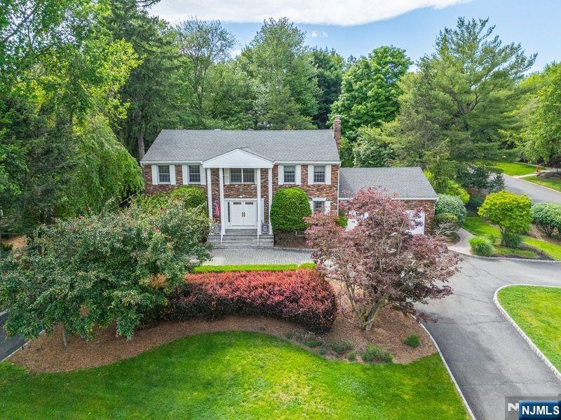 This stunning 5 BR/4.5 BTH Colonial located in the desirable town of Old Tappan is sure to impress the most discerning buyer. Set in one of Bergen County's most sought-after neighborhoods, this residence offers exceptional scale, functionality, & endless potential across approx. 5,460 sq. ft. Lovingly maintained by its original owner, this home reflects pride of ownership throughout. Upon entering, you'll be greeted by an elegant EF & formal LR that flows into a banquet-sized DR with gleaming hrdwd floors. The Gourmet MEIK features a center granite island, custom cabinetry, designer fixtures, & top-of-the-line appliances. The adjacent GR with soaring ceilings & a statement fireplace creates an inviting atmosphere for gatherings. A private Den, Lndry Rm, Pwdr Rm, & access to the oversized 2-Car Garage complete the main level. Upstairs, the Primary Suite features 2 W.I.C.'s & a spa-inspired FB with oversized shower, jetted tub & Water Closet. A Jr. Suite, 3 add'l BRs, & a FB complete the upper level. The Finished Bsmnt offers the ultimate in entertainment featuring a Bar, Home Theater, Home Gym, Dance Studio, cedar closet, workshop & abundant storage. The park-like yard w/ a waterfall feature is fully fenced-in, providing both tranquility & a wonderful space to entertain. An opportunity for buyers seeking exceptional space, oversized rooms, & endless potential in a premier Old Tappan location close to top-rated schools, parks, shopping, dining, & an EZ commute to New York City.