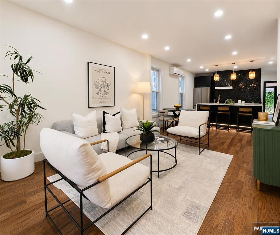 Welcome to 22 Union Street, a stunning gut-renovated single-family home with a bonus unit in the heart of Bergen-Lafayette, one of Jersey City's fastest-growing neighborhoods. This bright and airy residence blends timeless charm with modern luxury, featuring brand-new hardwood floors, an open-concept living and dining area, and a beautifully designed chef's kitchen centered around a striking oversized island perfect for entertaining. Natural light pours throughout the home, creating a warm and inviting atmosphere across every level. Offering 2 spacious bedrooms, a flexible den/home office, and 4 bathrooms, this thoughtfully designed layout delivers both comfort and versatility. The finished basement with private entryway adds incredible bonus living space ideal for guests, recreation, a studio, or extended living. Enjoy seamless backyard access perfect for summer gatherings, gardening, or quiet outdoor relaxation. Washer and dryer conveniently located on the main living floor. Located moments from Berry Lane Park, trendy cafes, local restaurants, and the Hudson-Bergen Light Rail, this home offers the perfect balance of neighborhood charm and commuter convenience with quick access to Downtown Jersey City and NYC. A rare opportunity to own a turnkey Bergen-Lafayette gem surrounded by growth, culture, green space, and vibrant city energy.