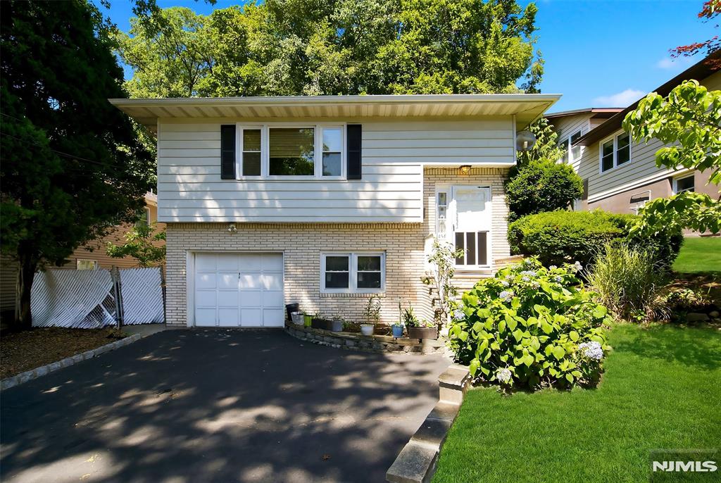 Welcome home to this spacious 2,300 sq. ft. 4-bedroom, 2-bath residence offering a versatile layout designed for comfortable living. The main level features a bright living room, formal dining room, well-appointed kitchen, and lower level family room, providing plenty of space for everyday living and entertaining. A 1-car garage adds convenience and extra storage. Step outside to enjoy the private backyard, perfect for relaxing, or hosting gatherings. Ideally located close to NYC with easy access to major roadways, commuting is a breeze. Conveniently situated near shopping, dining, parks, and everyday amenities, this home offers the perfect combination of space, comfort, and accessibility. Don't miss this fantastic opportunity!