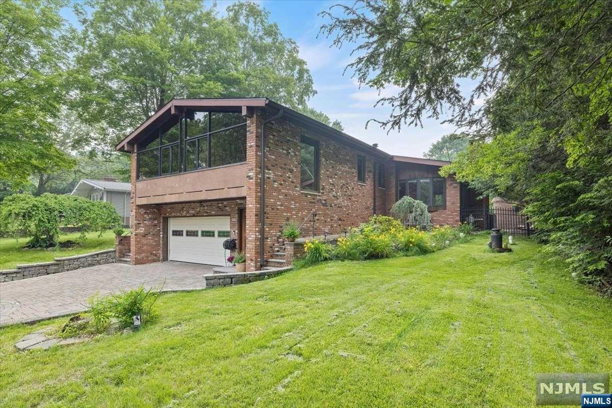This unique modern contemporary 3 BR home w/5 FB in a natural setting on a quiet circle near Echo Lake is beautiful inside&out! The ground floor features an entertainment area with wood-burning stove, & a rec room with pool table, wet bar, & a new FB. The exercise room leads you to the pool & garden. A beautiful spiral staircase leads to the great room/dining area. The gourmet kitchen is a chef's dream. 2 BR'S are on this floor, the primary br w/walk-in closet, FB w/sauna & bidet.The 2nd BR w/FB to the side. The gorgeous cherry wood LR has a beautiful brick fireplace w/sliding glass door to the backyard. The 3rd in-suite BR has a sliding door w/access to the pool. The floor-to-ceiling windows offer panoramic views of the gorgeous backyard paradise. The gunite heated in-ground pool w/jacuzzi, Gazebo, pool house w/FB. Plenty of entertaining areas. The established garden features Japanese Maple trees & sprinkler system. Perfect for entertaining-a one-of-a-kind gem!