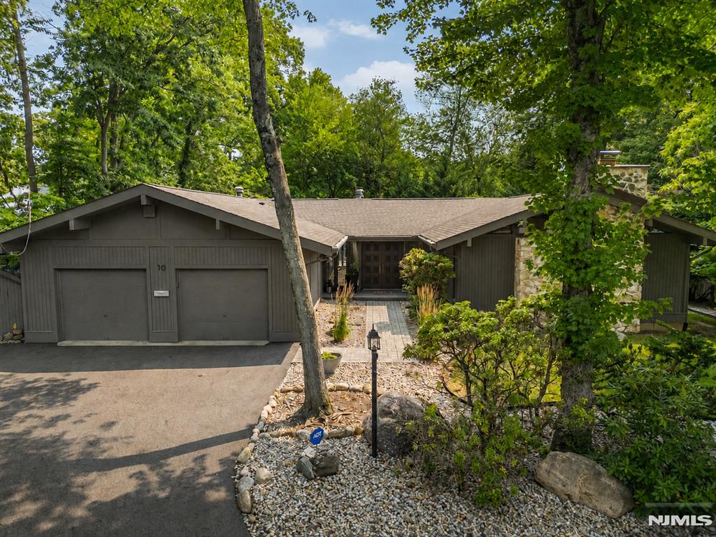 Welcome to your own private staycation retreat at 10 Reed Ct, where luxury, comfort and resort style living come together on a beautiful half acre in one of Wayne's most desirable neighborhoods. This exceptional ranch style home offers 3,025 sf of thoughtfully designed living space plus a finished lower level. The home features five bedrooms, one currently used as an office, along with four recently remodeled bathrooms. At the heart of the home is a stunning, newly renovated gourmet kitchen featuring high-end appliances, two islands & an open flow that is perfect for everyday living & entertaining. Spacious sun-filled rooms, thoughtful updates & quality craftsmanship provide the perfect balance of elegance & functionality. Adding warmth & charm are two wood-burning fireplaces, perfect for cozy evenings. The finished walk-out lower level offers exceptional flexibility with a large rec room and additional living space ideal for guests, a home office, gym, or media room. Step outside and discover your own backyard oasis. The heated Gunite pool with spa, Trex deck, expansive patio, & lush, private yard create an incredible setting for entertaining or simply relaxing in complete privacy. Located on a quiet cul-de-sac in the highly desirable Wayne Hills section, you will enjoy a neighborhood setting while being close to top-rated schools, shopping, & major transportation. 10 Reed Ct is truly a rare opportunity to own a home where every day feels like a resort getaway.