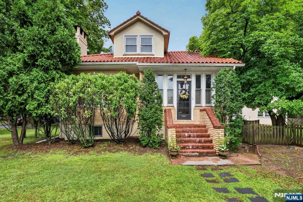 Welcome to this warm & inviting all-brick home in Mahwah's sought-after Fardale neighborhood, perfectly situated on a private, level half-acre corner lot. The coveted driveway entrance from Parsloe Ct, a desirable cul-de-sac, provides added privacy & convenience. A distinctive Spanish tile roof & Pella windows enhance the home's timeless character & curb appeal. At the heart of the home is an impressive 20' x 30' LR, filled w natural light from an abundance of windows. Rich walnut moldings, gorgeous hardwood floors, & a classic wood-burning fireplace create an elegant yet comfortable space ideal for everyday living & entertaining. The charming country kitchen, complete w a center island, offers a welcoming gathering place for family and friends and flows effortlessly into the elegant, formal dining room, perfect for holiday dinners. The home features four BRs, including a convenient first-floor primary suite, along w two FBATHs. The finished basement features a second fireplace & provides valuable additional living space. Step outside onto the expansive wood deck overlooking the beautifully level backyard. A lovely two-car garage & the exceptional privacy of this prime corner location complete the property. Offering classic architecture, generous living spaces, & an exceptional setting, this distinctive home is ready to welcome its next owners. Contact Laurie Jordan 201-937-5070